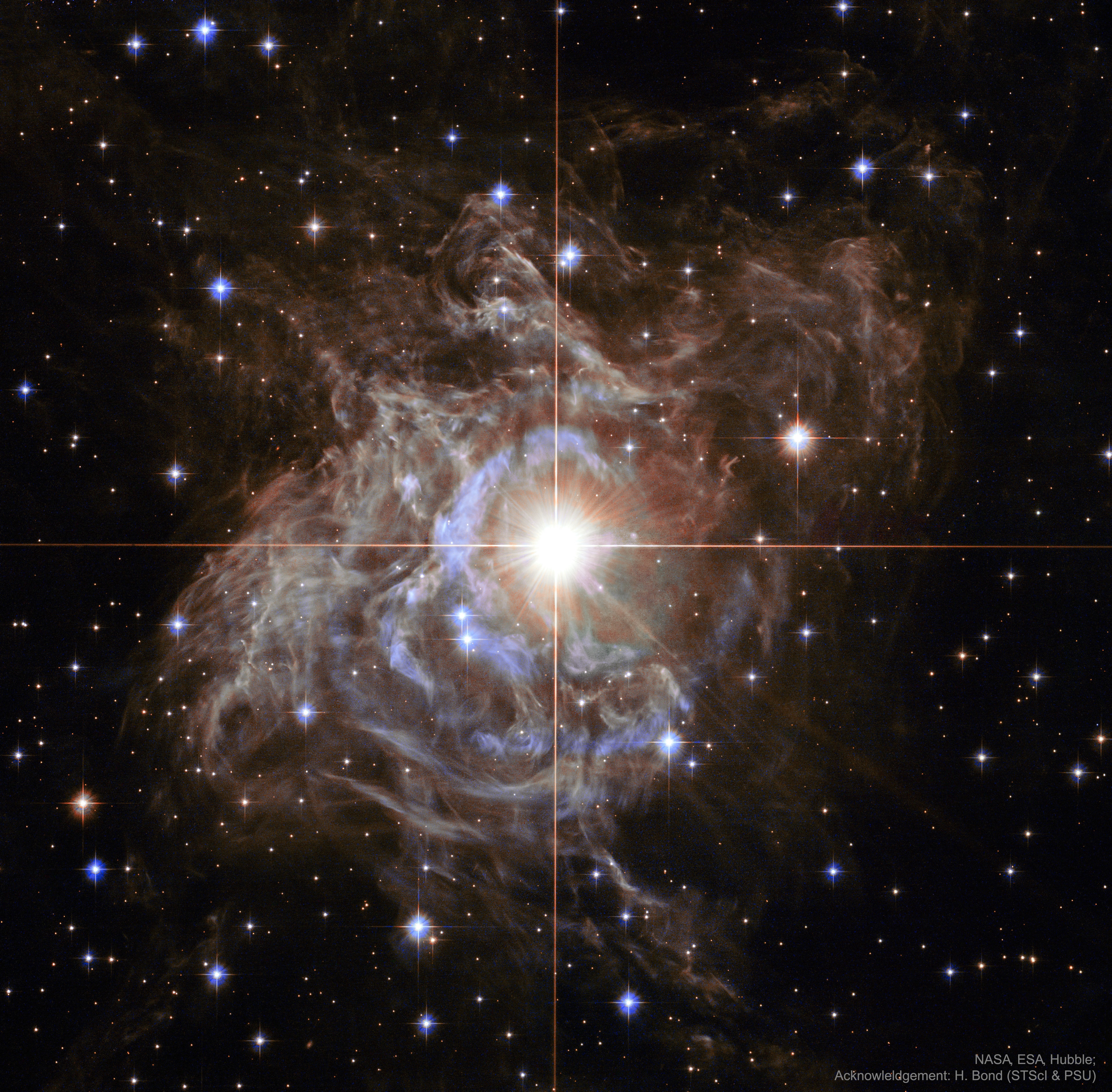 In the center is one of the most important stars on the sky. This is partly because, by coincidence, it is surrounded by a dazzling reflection nebula. Pulsating RS Puppis, the brightest star in the image center, is some ten times more massive than our Sun and on average 15,000 times more luminous. In fact, RS Pup is a Cepheid type variable star, a class of stars whose brightness is used to estimate distances to nearby galaxies as one of the first steps in establishing the cosmic distance scale. As RS Pup pulsates over a period of about 40 days, its regular changes in brightness are also seen along the nebula delayed in time, effectively a light echo. Using measurements of the time delay and angular size of the nebula, the known speed of light allows astronomers to geometrically determine the distance to RS Pup to be 6,500 light-years, with a remarkably small error of plus or minus 90 light-years. An impressive achievement for stellar astronomy, the echo-measured distance also more accurately establishes the true brightness of RS Pup, and by extension other Cepheid stars, improving the knowledge of distances to galaxies beyond the Milky Way. The featured image was taken by the Hubble Space Telescope.