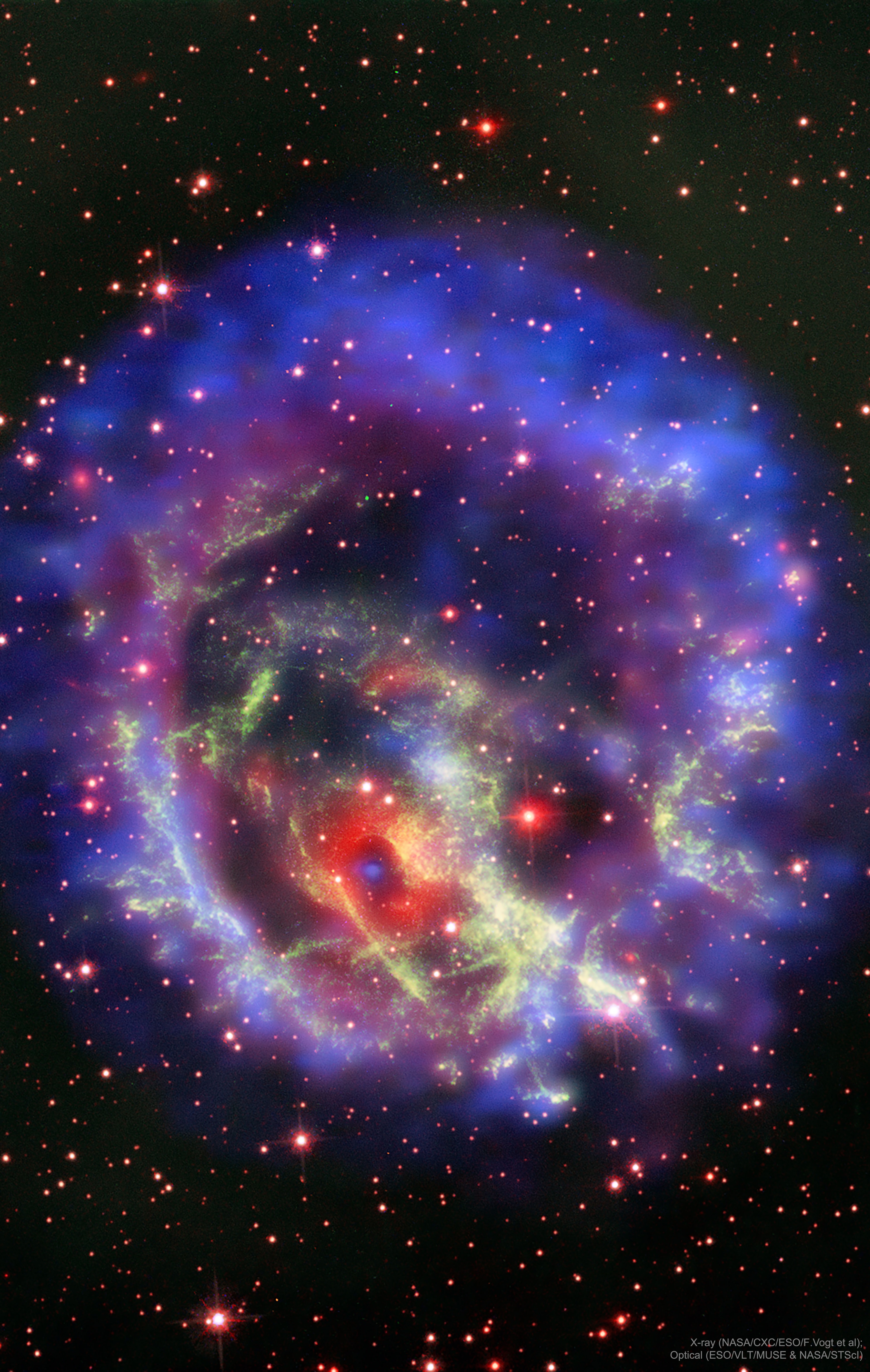 Why is this neutron star off-center? Recently a lone neutron star has been found within the debris left over from an old supernova explosion. The "lonely neutron star" in question is the blue dot at the center of the red nebula near the bottom left of E0102-72.3.  In the featured image composite, blue represents X-ray light captured by NASA's Chandra Observatory, while red and green represent optical light captured by ESO's Very Large Telescope in Chile and NASA's Hubble Space Telescope in orbit.  The displaced position of this neutron star is unexpected since the dense star is thought to be the core of the star that exploded in the supernova and created the outer nebula.  It could be that the neutron star in E0102 was pushed away from the nebula's center by the supernova itself, but then it seems odd that the smaller red ring remains centered on the neutron star.  Alternatively, the outer nebula could have been expelled during a different scenario -- perhaps even involving another star.  Future observations of the nebulas and neutron star appear likely to resolve the situation.