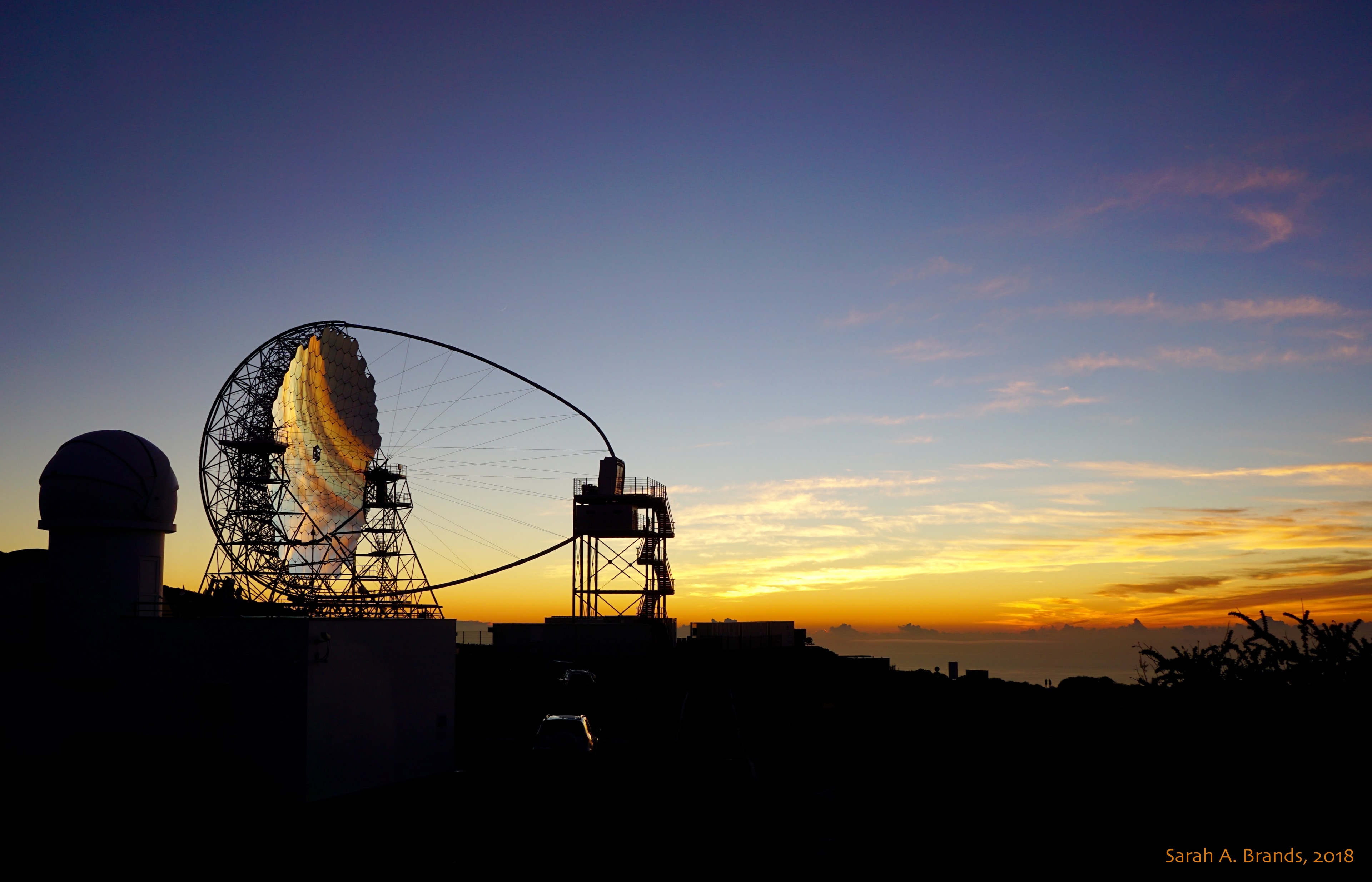 On October 10, a new telescope reflected the light of the setting Sun. With dark horizon above and sunset colors below, its segmented mirror inverts an image of the beautiful evening sky in this snapshot from the Roque del Los Muchachos Observatory on the Canary Island of La Palma. The mirror segments cover a 23 meter diameter and are mounted in the open structure of the Large Scale Telescope 1, inaugurated as the first component of the Cherenkov Telescope Array (CTA). Most ground-based telescopes are hindered by the atmosphere that blurs, scatters, and absorbs light. But cherenkov telescopes are designed to detect very high energy gamma rays and actually require the atmosphere to operate. As the gamma rays impact the upper atmosphere they produce air showers of high-energy particles. A large, fast camera at the common focus images the brief flashes of optical light, called Cherenkov light, created by the air shower particles. The flashes reveal the incoming gamma ray timing, direction, and energy. Ultimately more than 100 Cherenkov telescopes are planned for the CTA at locations in both northern and southern hemispheres on planet Earth.
