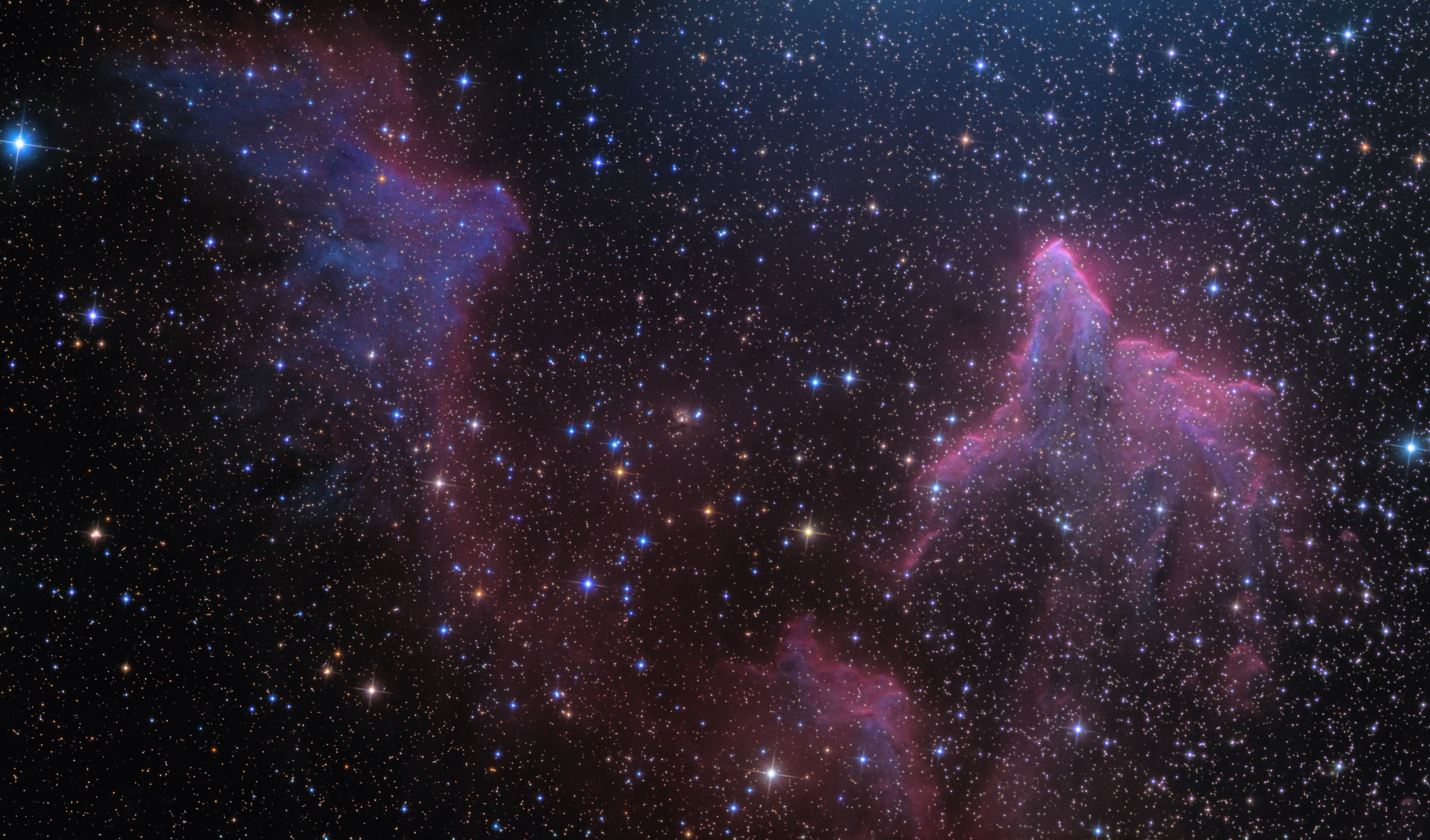 These bright rims and flowing shapes look ghostly on a cosmic scale. A telescopic view toward the constellation Cassiopeia, the colorful (zoomable) skyscape features the swept-back, comet-shaped clouds IC 59 (left) and IC 63. About 600 light-years distant, the clouds aren't actually ghosts, but they are slowly disappearing under the influence of energetic radiation from hot,luminous star gamma Cas. Gamma Cas is physically located only 3 to 4 light-years from the nebulae, just off the top right edge of the frame. Slightly closer to gamma Cas, IC 63 is dominated by red H-alpha light emitted as hydrogen atoms ionized by the star's ultraviolet radiation recombine with electrons. Farther from the star, IC 59 shows proportionally less H-alpha emission but more of the characteristic blue tint of dust reflected star light. The field of view spans about 1 degree or 10 light-years at the estimated distance of gamma Cas and friends.