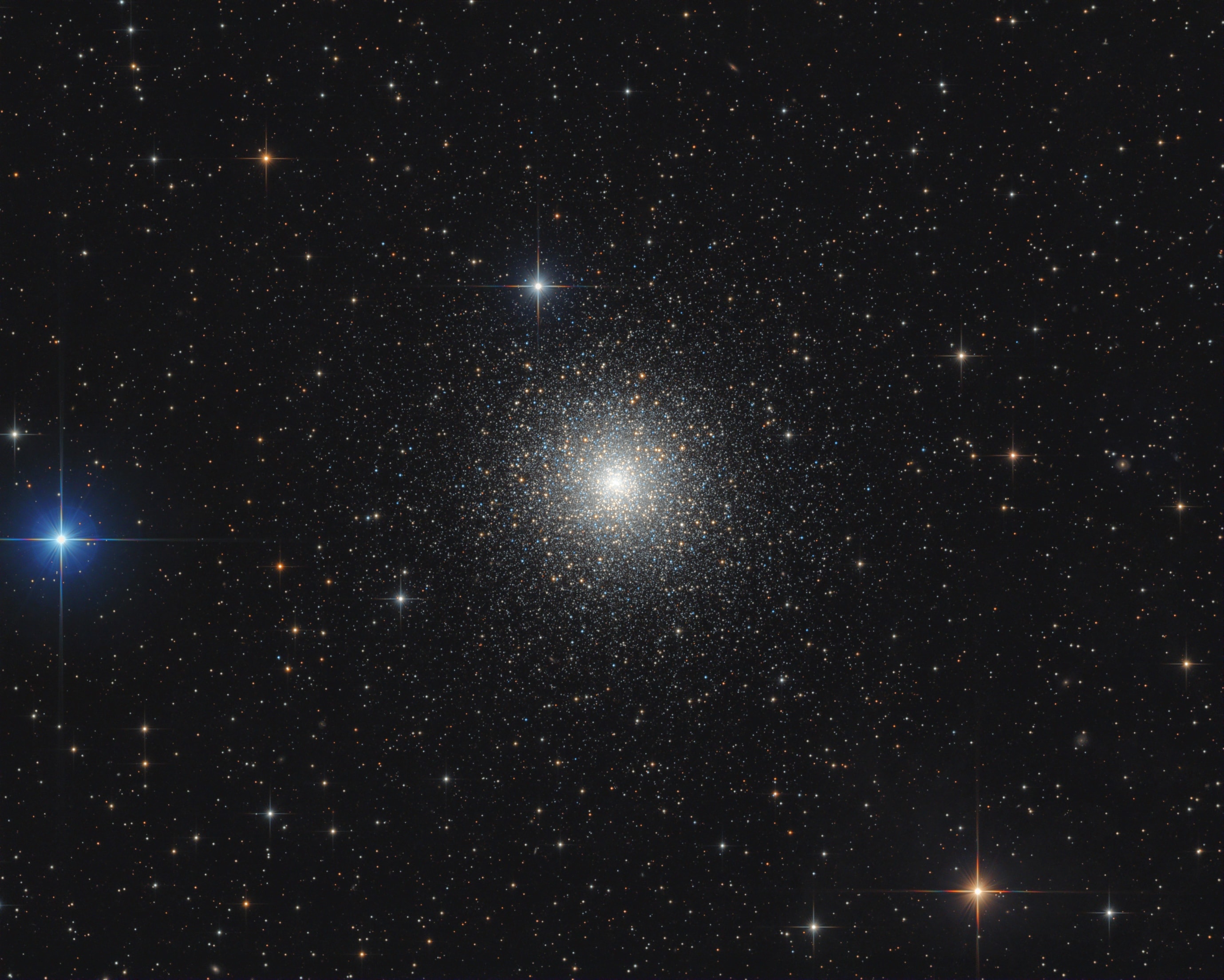 Messier 15 is an immense swarm of over 100,000 stars. A 13 billion year old relic of the early formative years of our galaxy it's one of about 170 globular star clusters that still roam the halo of the Milky Way. Centered in this sharp telescopic view, M15 lies about 35,000 light years away toward the constellation Pegasus, well beyond the spiky foreground stars. Its diameter is about 200 light-years. But more than half its stars are packed into the central 10 light-years or so, one of the densest concentrations of stars known. Hubble-based measurements of the increasing velocities of M15's central stars are evidence that a massive black hole resides at the center of dense globular cluster M15.
