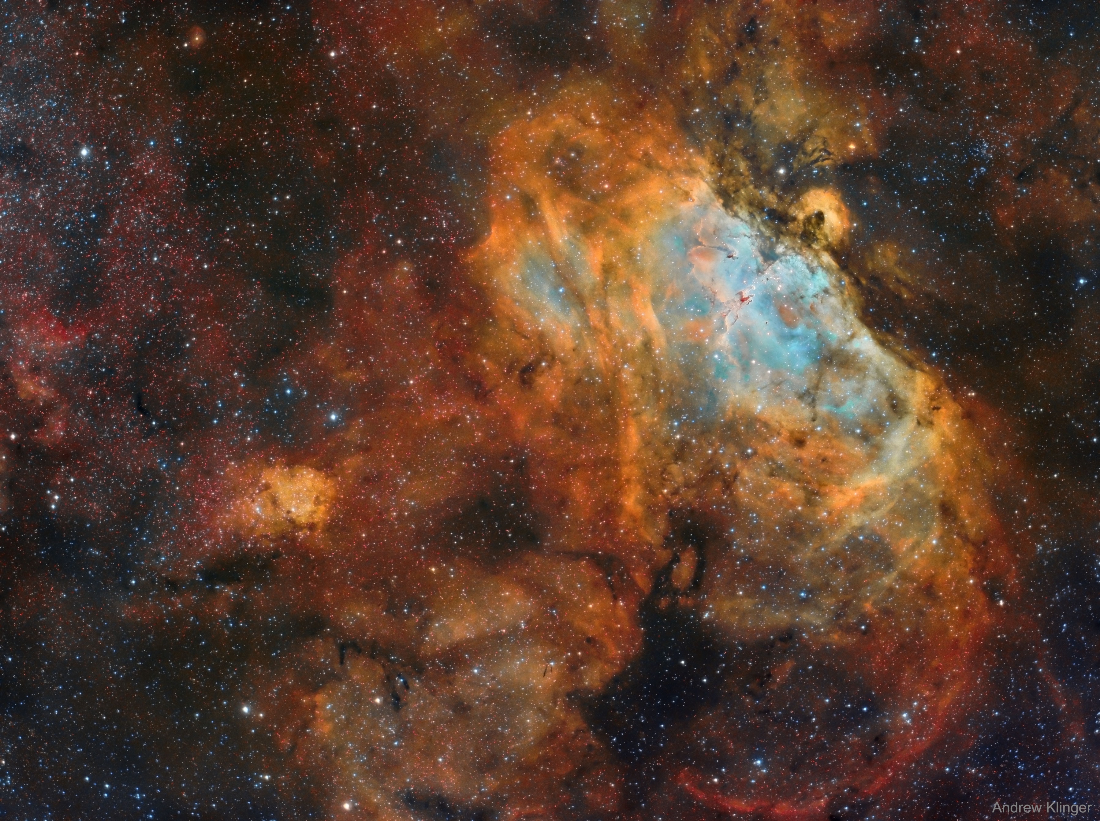 From afar, the whole thing looks like an Eagle.  A closer look at the Eagle Nebula, however, shows the bright region is actually a window into the center of a larger dark shell of dust.  Through this window, a brightly-lit workshop appears where a whole open cluster of stars is being formed.  In this cavity tall pillars and round globules of dark dust and cold molecular gas remain where stars are still forming.  Already visible are several young bright blue stars whose light and winds are burning away and pushing back the remaining filaments and walls of gas and dust.  The Eagle emission nebula, tagged M16, lies about 6500 light years away, spans about 20 light-years, and is visible with binoculars toward the constellation of the Serpent (Serpens).  This picture involved over 25 hours of imaging and combines three specific emitted colors emitted by sulfur (colored as red), hydrogen (yellow), and oxygen (blue).