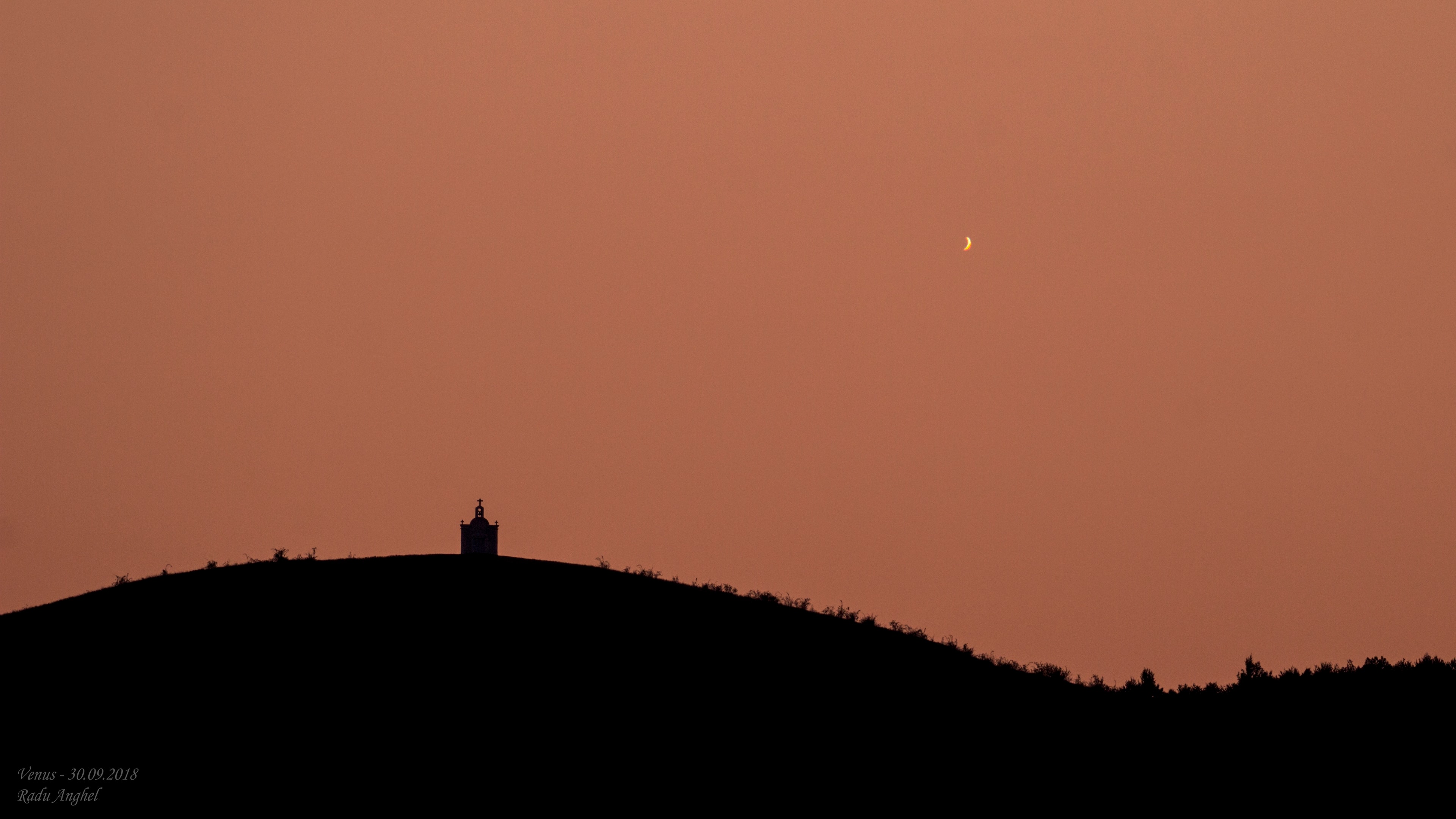 That's not a young crescent Moon poised above the hills along the western horizon at sunset. It's Venus in a crescent phase. About 54 million kilometers away and less than 20 percent illuminated, it was captured by telescope and camera on September 30 near Bacau, Romania. The bright celestial beacon is now languishing in the evening twilight, its days as the Evening Star in 2018 coming to a close. But it also grows larger in apparent size and becomes an ever thinner crescent in telescopic views. Heading toward an inferior conjunction (non-judgmental), the inner planet will be positioned between Earth and Sun on October 26 and lost from view in the solar glare. At month's end a crescent Venus will reappear in the east though, rising just before the Sun as the brilliant Morning Star.