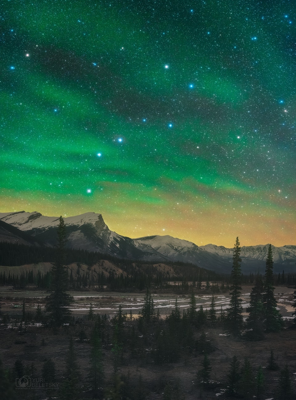 The best known asterism in northern skies hangs over the Canadian Rockies in this mountain and night skyscape taken last week from Banff National Park. But most remarkable is the amazing greenish airglow. With airglow visible to the eye, but not in color, the scene was captured in two exposures with a single camera, one exposure made while tracking the stars and one fixed to a tripod. Airglow emission is predominately from atmospheric oxygen atoms at extremely low densities. Commonly recorded in color by sensitive digital cameras the eerie, diffuse light is seen here in waves across the northern night. Originating at an altitude similar to aurorae, the luminous airglow is due to chemiluminescence, the production of light through chemical excitation and radiative decay. Energy for the chemical excitation is provided during daytime by the Sun's extreme ultraviolet radiation. Unlike aurorae which are limited to high latitudes, airglow can be found around the globe.