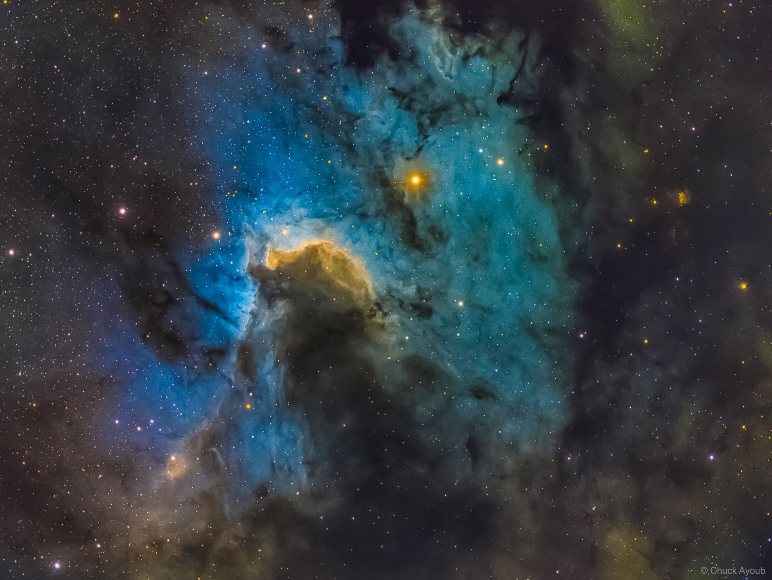 What's inside this cosmic cave? A stellar nursery 10 light-years deep.  The featured skyscape is dominated by dusty Sh2-155, the Cave Nebula. In the telescopic image, data taken through a narrowband filters tracks the nebular glow of hydrogen, oxygen, and sulfur, colors that together form the Hubble Palette.  About 2,400 light-years away, the scene lies along the plane of our Milky Way Galaxy toward the royal northern constellation of Cepheus. Astronomical explorations of the region reveal that it has formed at the boundary of the massive Cepheus B molecular cloud and the hot, young stars of the Cepheus OB 3 association. The bright rim of ionized hydrogen gas is energized by radiation from the hot stars, dominated by the bright star just to the left of the cave entrance. Radiation driven ionization fronts are likely triggering collapsing cores and new star formation within.