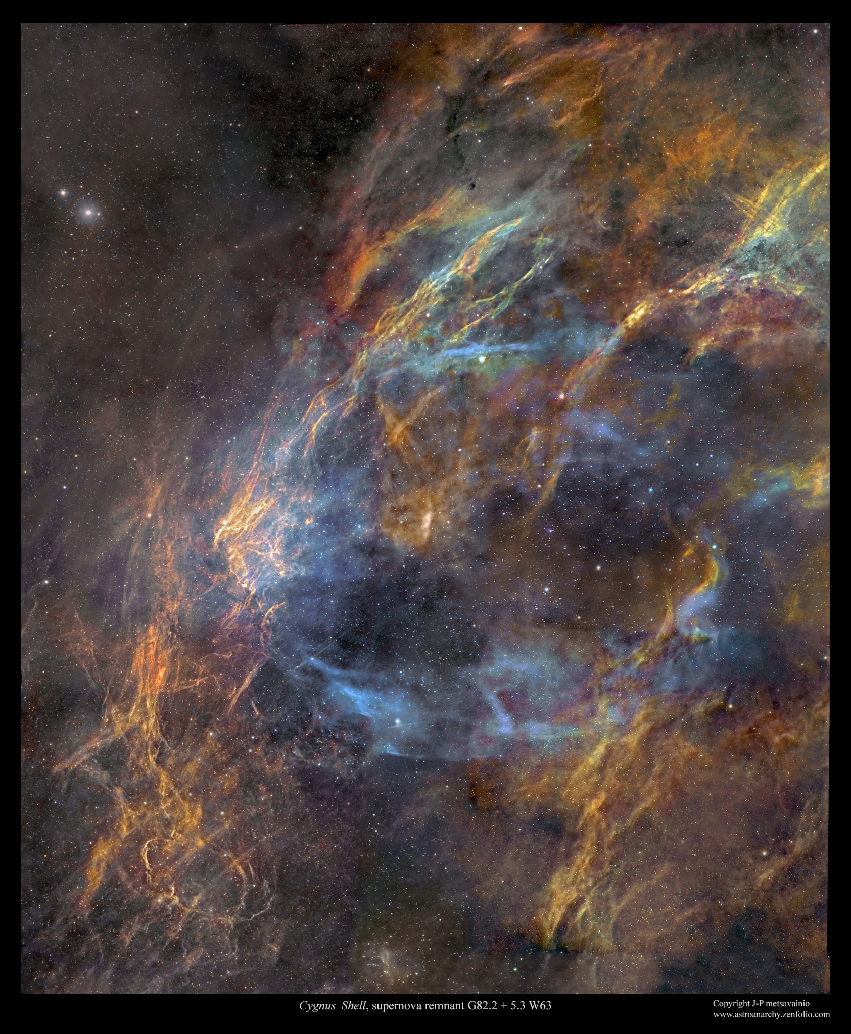 The ghost of a long-dead star, the W63 supernova remnant shines like a faint cosmic smoke-ring along the plane of the Milky Way galaxy toward the northern constellation Cygnus the swan. Its wraithlike appearance is traced against the region's rich complex of interstellar clouds and dust by an eerie blue glow. Spanning over four full moons on the sky, the beautiful image is a telescopic mosaic in twelve panels that combines 100 hours of exposure time using narrow band filters. It shows characteristic light from ionized atoms of sulfur, hydrogen and oxygen in red, green, and blue hues. Likely over 5,000 light-years away, the visible part of the still expanding shell supernova remnant is around 150 light-years in diameter. So far no source has been identified as with the remains of W63's original star. Light from the star's supernova explosion would have reached Earth over 15,000 years ago.