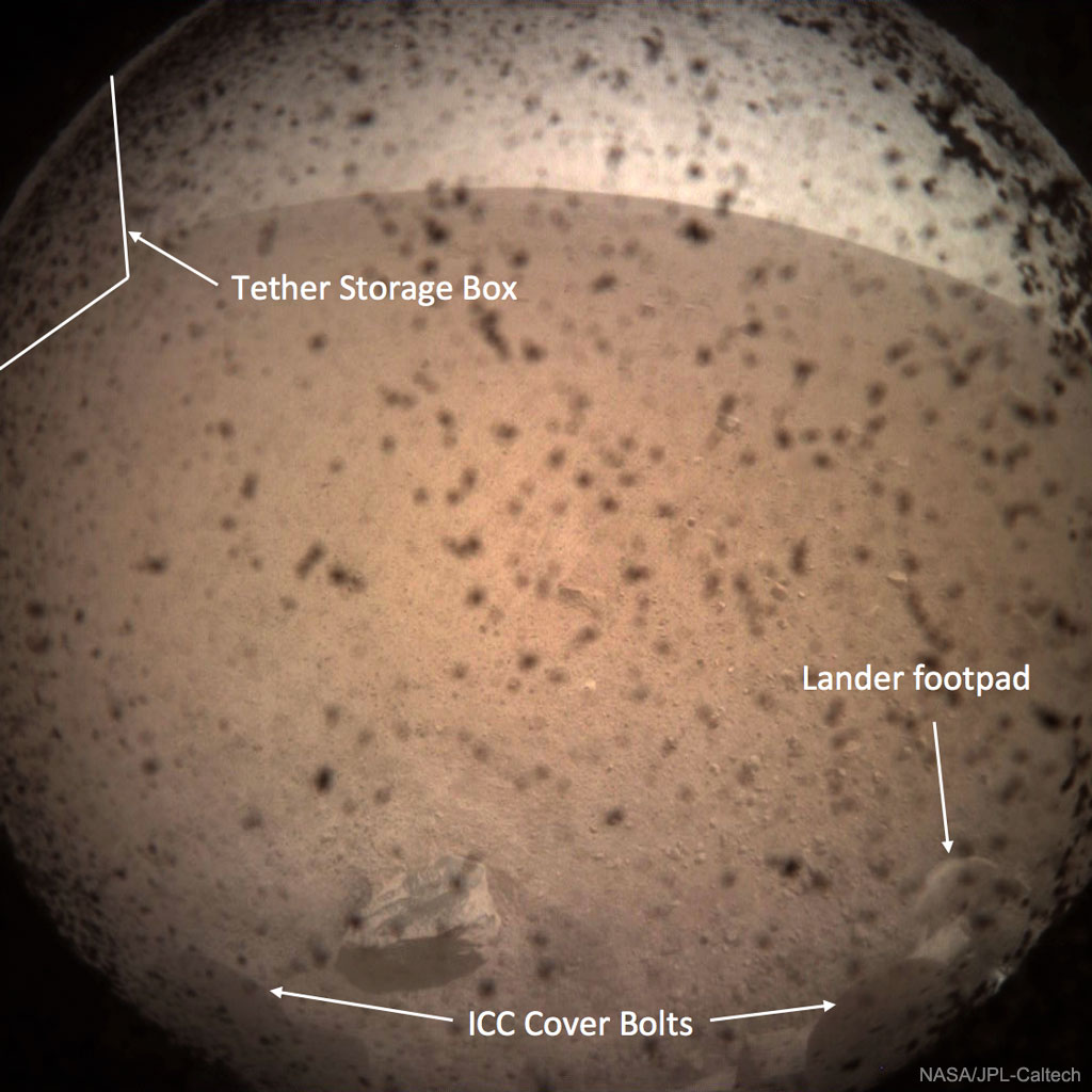 Welcome to Mars, NASA Insight.  Yesterday NASA's robotic spacecraft InSight made a dramatic landing on Mars after a six-month trek across the inner Solar System. Needing to brake from 20,000 km per hour to zero in about seven minutes, Insight decelerated by as much as 8  g's and heated up to 1500 degrees Celsius as it deployed a heat shield, a parachute, and at the end, rockets.  The featured image was the first taken by InSight on Mars, and welcome proof that the spacecraft had shed enough speed to land softly and function on the red planet. During its final descent, InSight's rockets kicked up dust which can be seen stuck to the lens cap of the Instrument Context Camera. Past the spotty dirt, parts of the lander that are visible include cover bolts at the bottom and a lander footpad on the lower right. Small rocks are visible across the rusty red soil, while the arc across the top of the image is the Martian horizon dividing land and sky. Over the next few weeks InSight will deploy several scientific instruments, including a rumble-detecting seismometer.  These instruments are expected to give humanity unprecedented data involving the interior of Mars, a region thought to harbor formation clues not only about Mars, but Earth.