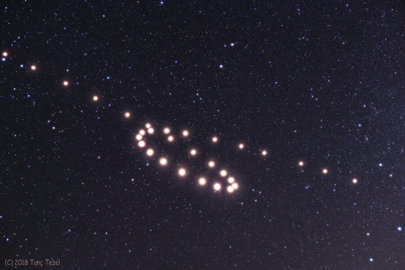 This composite of images spaced some 5 to 9 days apart, from late April (bottom right) through November 5 (top left), traces the retrograde motion of ruddy-colored Mars through planet Earth's night sky. To connect the dots and dates in this 2018 Mars retrograde loop, just slide your cursor over the picture (and check out this animation). But Mars didn't actually reverse the direction of its orbit. Instead, the apparent backwards motion with respect to the background stars is a reflection of the motion of the Earth itself. Retrograde motion can be seen each time Earth overtakes and laps planets orbiting farther from the Sun, the Earth moving more rapidly through its own relatively close-in orbit.  On July 27, Mars was near its favorable 2018 perihelic opposition, when Mars was closest to the Sun in its orbit while also opposite the Sun in Earth's sky. For that date, the frame used in this composite was taken during the total lunar eclipse.