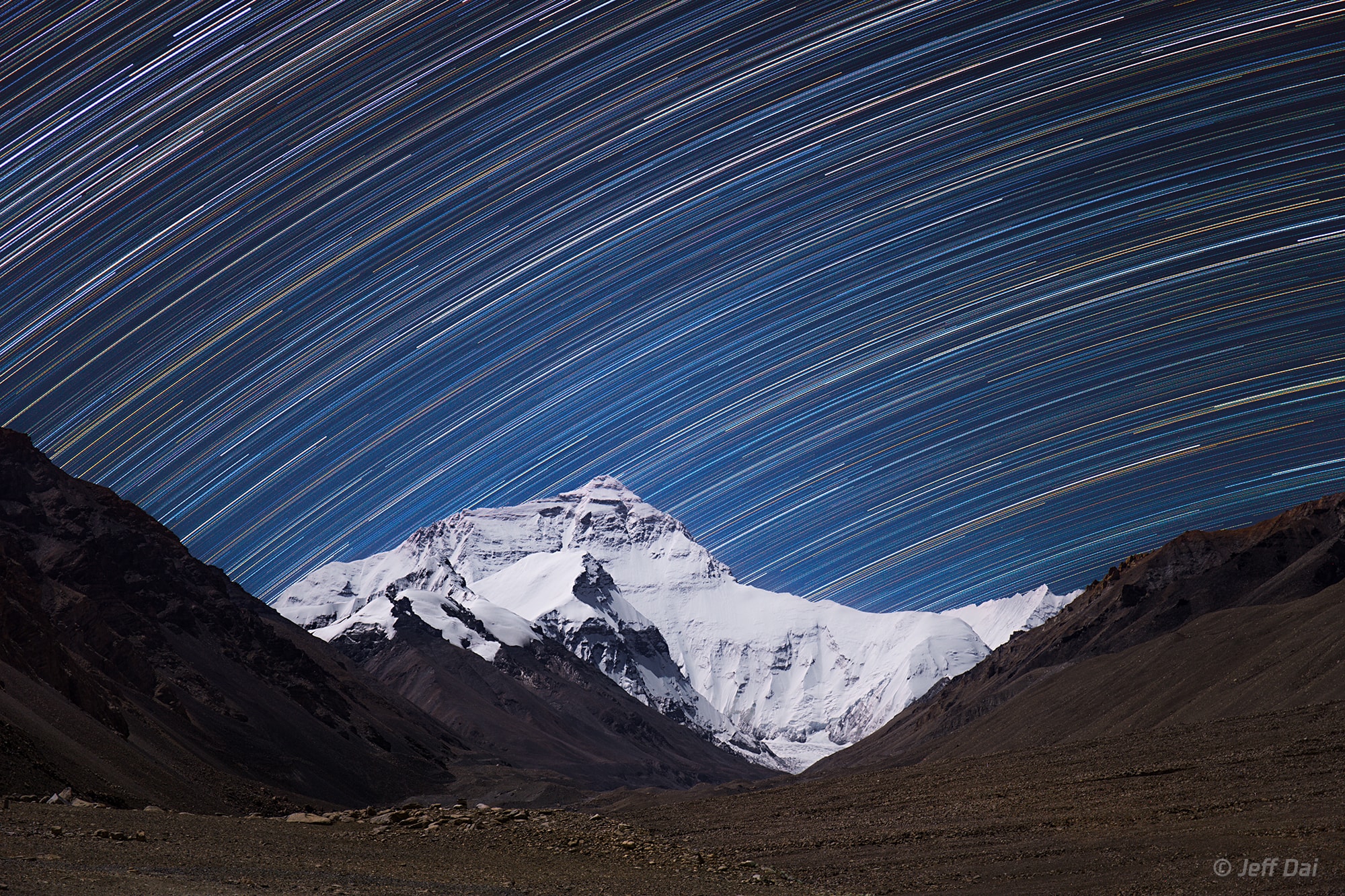 The highest peak on planet Earth is framed in this mountain and night skyscape. On September 30, the digital stack of 240 sequential exposures made with a camera fixed to a tripod at an Everest Base Camp captured the sheer north face of the Himalayan mountain and foreground illuminated by bright moonlight. Taken over 1.5 hours, the sequence also recorded colorful star trails. Reflecting the planet's daily rotation on its axis, their motion is along gentle concentric arcs centered on the south celestial pole, a point well below the rugged horizon. The color of the trails actually indicates the temperatures of the stars. Blueish hues are from hotter stars, and yellow to reddish hues are from stars cooler than the Sun.
