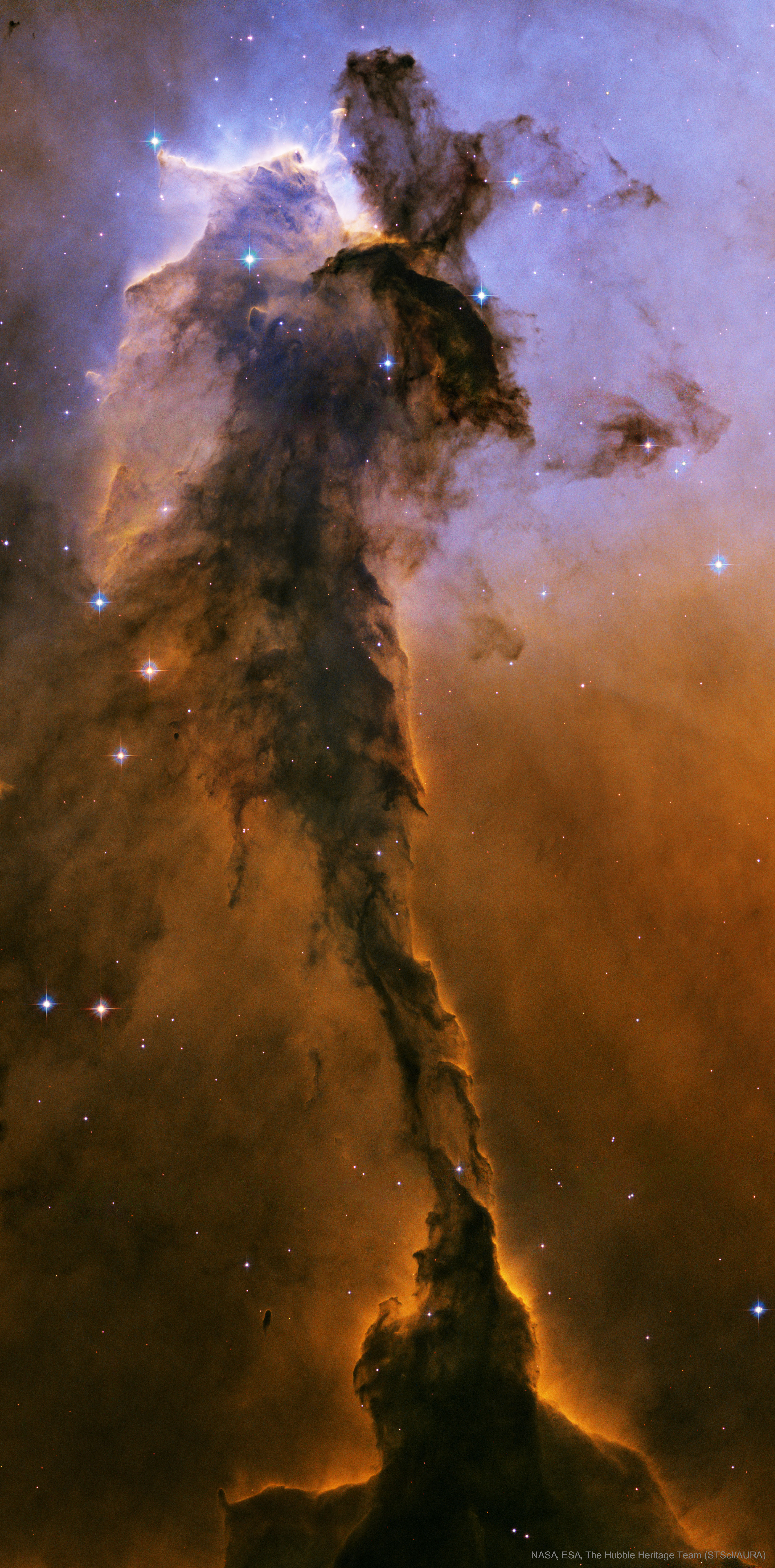 The dust sculptures of the Eagle Nebula are evaporating.  As powerful starlight whittles away these cool cosmic mountains, the statuesque pillars that remain might be imagined as mythical beasts.  Featured here is one of several striking dust pillars of the Eagle Nebula that might be described as a gigantic alien fairy.   This fairy, however, is ten light years tall and spews radiation much hotter than common fire. The greater Eagle Nebula, M16, is actually a giant evaporating shell of gas and dust inside of which is a growing cavity filled with a spectacular stellar nursery currently forming an open cluster of stars.  This great pillar, which is about 7,000 light years away, will likely evaporate away in about 100,000 years.  The featured image in scientifically re-assigned colors was released in 2005 as part of the fifteenth anniversary celebration of the launch of the Hubble Space Telescope.   New: Instagram page features cool images recently submitted to APOD