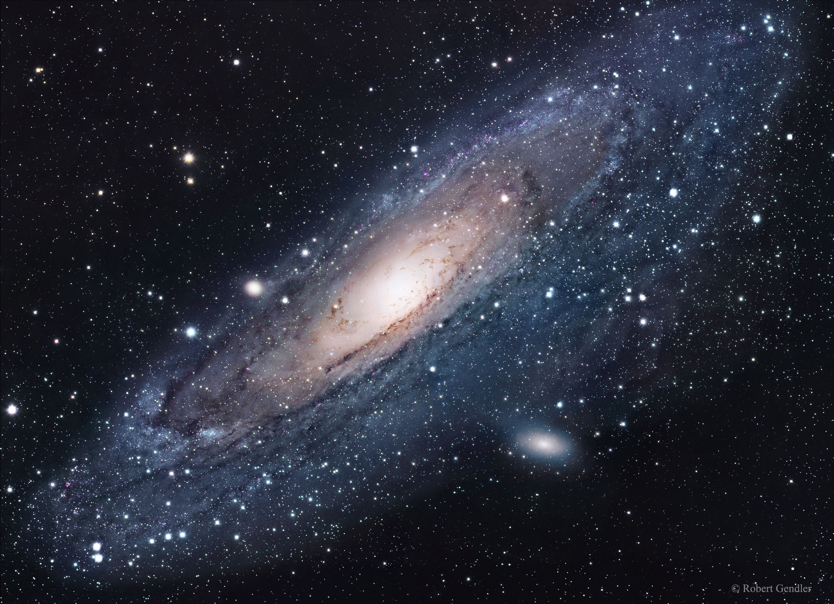 What is the nearest major galaxy to our own Milky Way Galaxy?  Andromeda.  In fact, our Galaxy is thought to look much like Andromeda. Together these two galaxies dominate the Local Group of galaxies. The diffuse light from Andromeda is caused by the hundreds of billions of stars that compose it. The several distinct stars that surround Andromeda's image are actually stars in our Galaxy that are well in front of the background object. Andromeda is frequently referred to as M31 since it is the 31st object on Messier's list of diffuse sky objects. M31 is so distant it takes about two million years for light to reach us from there. Although visible without aid, the featured image of M31 is a digital mosaic of 20 frames taken with a small telescope. Much about M31 remains unknown, including exactly how long it will be before it  collides with our home galaxy.   Jump around the Universe: Random APOD Generator
