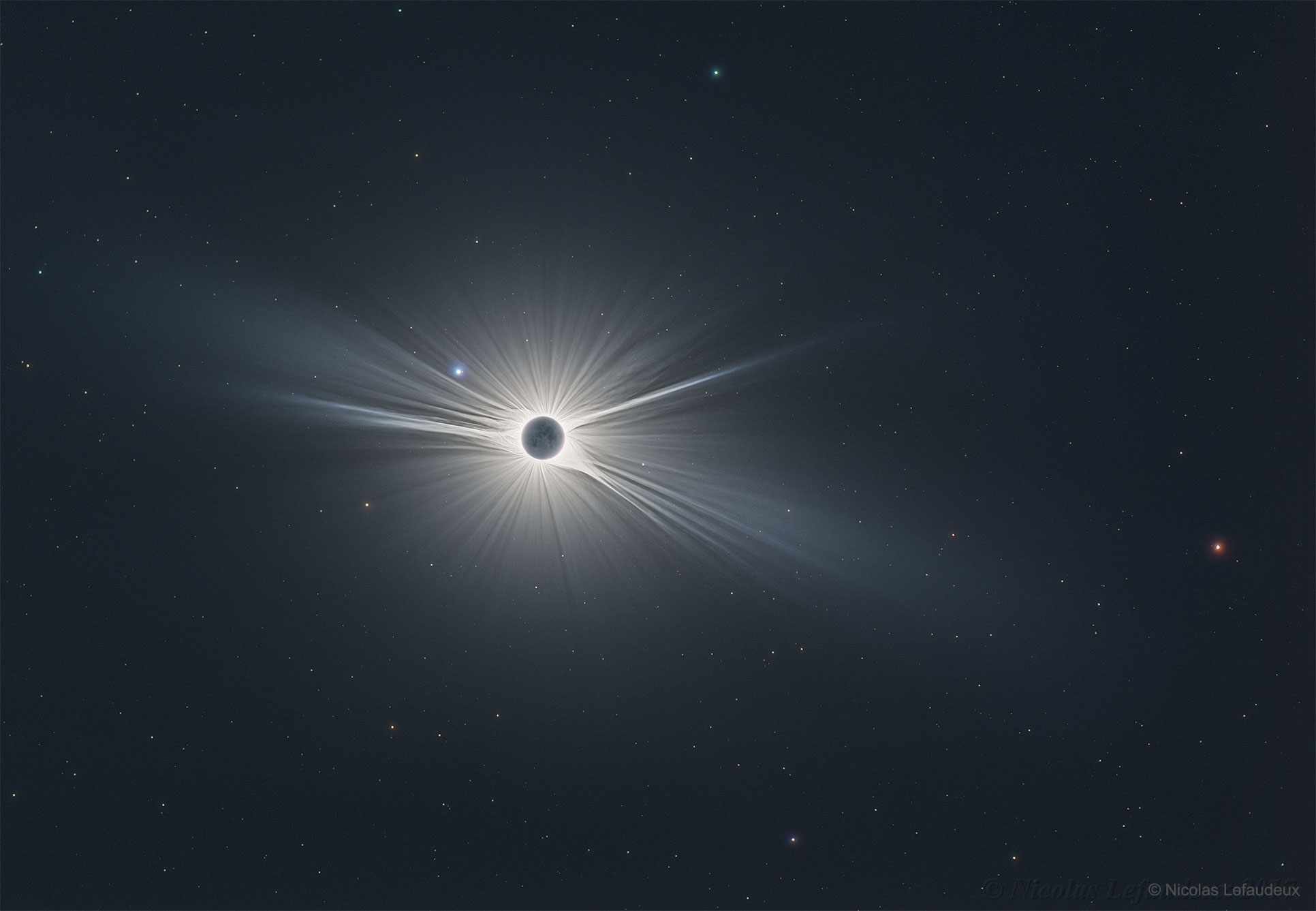 Only in the fleeting darkness of a total solar eclipse is the light of the solar corona easily visible. Normally overwhelmed by the bright solar disk, the expansive corona, the sun's outer atmosphere, is an alluring sight. But the subtle details and extreme ranges in the corona's brightness, although discernible to the eye, are notoriously difficult to photograph. Pictured here, however, using over 120 images and meticulous digital processing, is a detailed wide-angle image of the Sun's corona taken during the Great American Eclipse in 2017 August.  Clearly visible are intricate layers and glowing caustics of an ever changing mixture of hot gas and magnetic fields. Hundreds of stars as faint as 11th magnitude are visible behind the Moon and Sun, with Mars appearing in red on the far right.  The next total eclipse of the Sun will occur on July 2 and be visible during sunset from a thin swath across Chile and Argentina.