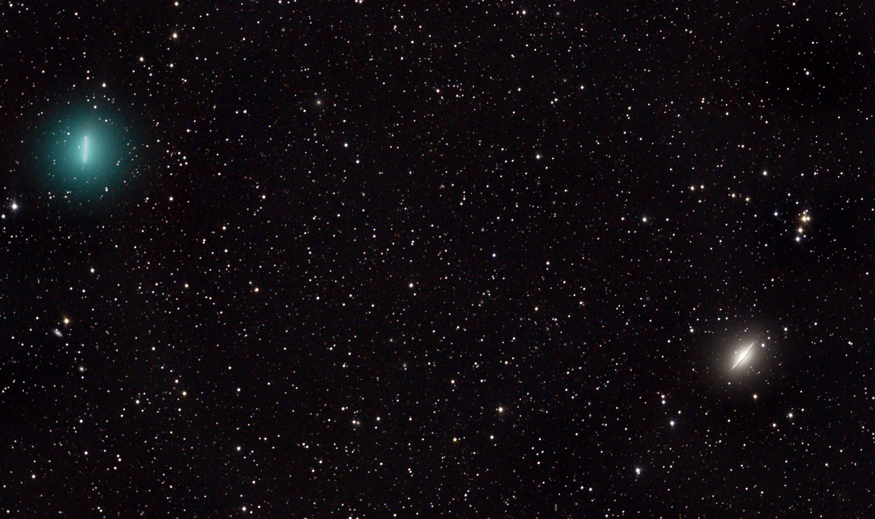 Comet Iwamoto (C/2018 Y1), shows off a pretty, greenish coma at the upper left in this telescopic field of view. Taken on February 4 from the Mount John Observatory, University of Canterbury, the 30 minute long total exposure time shows the comet sweeping quickly across a background of stars and distant galaxies in the constellation Virgo. The long exposure and Iwamoto's rapid motion relative to the stars and galaxies results in the noticeable blurred streak tracing the the comet's bright inner coma. In fact, the streaked coma gives the comet a remarkably similar appearance to Messier 104 at lower right, popularly known as the Sombrero Galaxy. The comet, a visitor to the inner Solar System, is a mere 4 light-minutes away though, while majestic Messier 104, a spiral galaxy posing edge-on, is 30 million light-years distant. The first binocular comet of 2019, Iwamoto will pass closest to Earth on February 12. This comet's highly elliptical orbit around the Sun stretches beyond the Kuiper belt with an estimated 1,371 year orbital period. That should bring it back to the inner Solar System in 3390 AD.