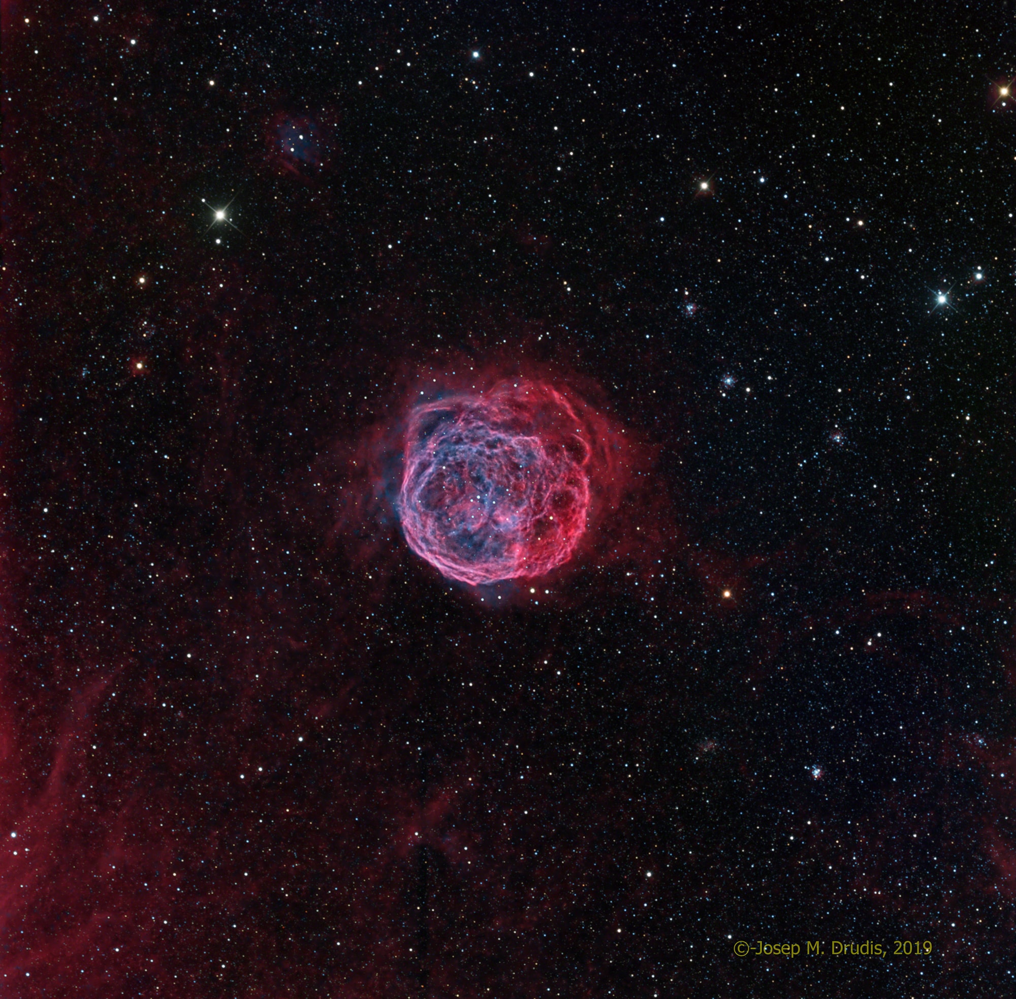 Massive stars profoundly affect their galactic environments.  Churning and mixing interstellar clouds of gas and dust, stars -- most notably those upwards of tens of times the mass of our Sun -- leave their mark on the compositions and locations of future generations of stars.  Dramatic evidence of this is illustrated in our neighboring galaxy, the Large Magellanic Cloud (LMC), by the featured nebula, Henize 70 (also known as N70 and DEM301).  Henize 70 is actually a luminous superbubble of interstellar gas about 300 light-years in diameter, blown by winds from hot, massive stars and supernova explosions, with its interior filled with tenuous hot and expanding gas.  Because superbubbles can expand through an entire galaxy, they offer humanity a chance to explore the connection between the lifecycles of stars and the evolution of galaxies.