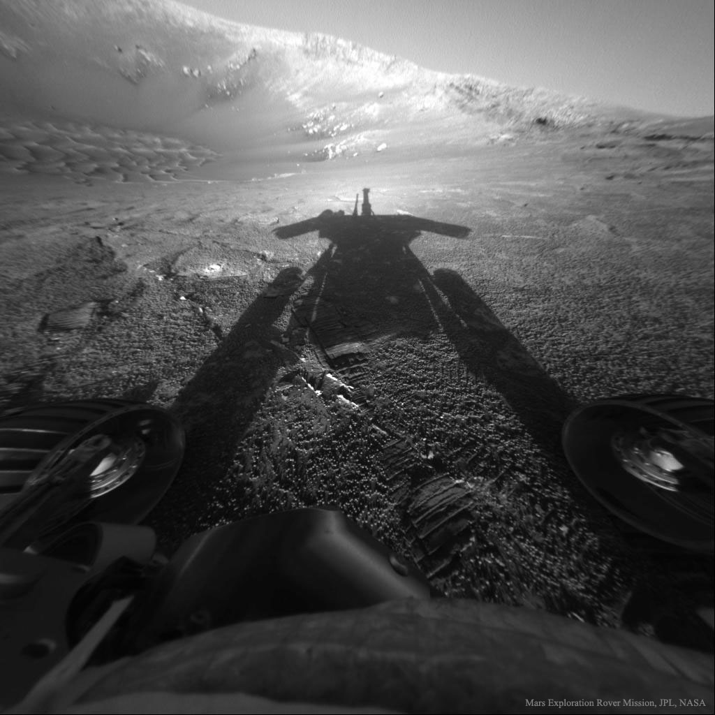 What if you saw your shadow on Mars and it wasn't human?  Then you might have been the Opportunity rover exploring Mars.  Opportunity explored the red planet from 2004 to 2018, finding evidence of ancient water, and sending breathtaking images across the inner Solar System.  Pictured here in 2004, Opportunity looks opposite the Sun into Endurance Crater and sees its own shadow.  Two wheels are visible on the lower left and right, while the floor and walls of the unusual crater are visible in the background.  Caught in a dust storm in 2018, last week NASA stopped trying to contact Opportunity and declared the ground-breaking mission, originally planned for only 92 days, complete.