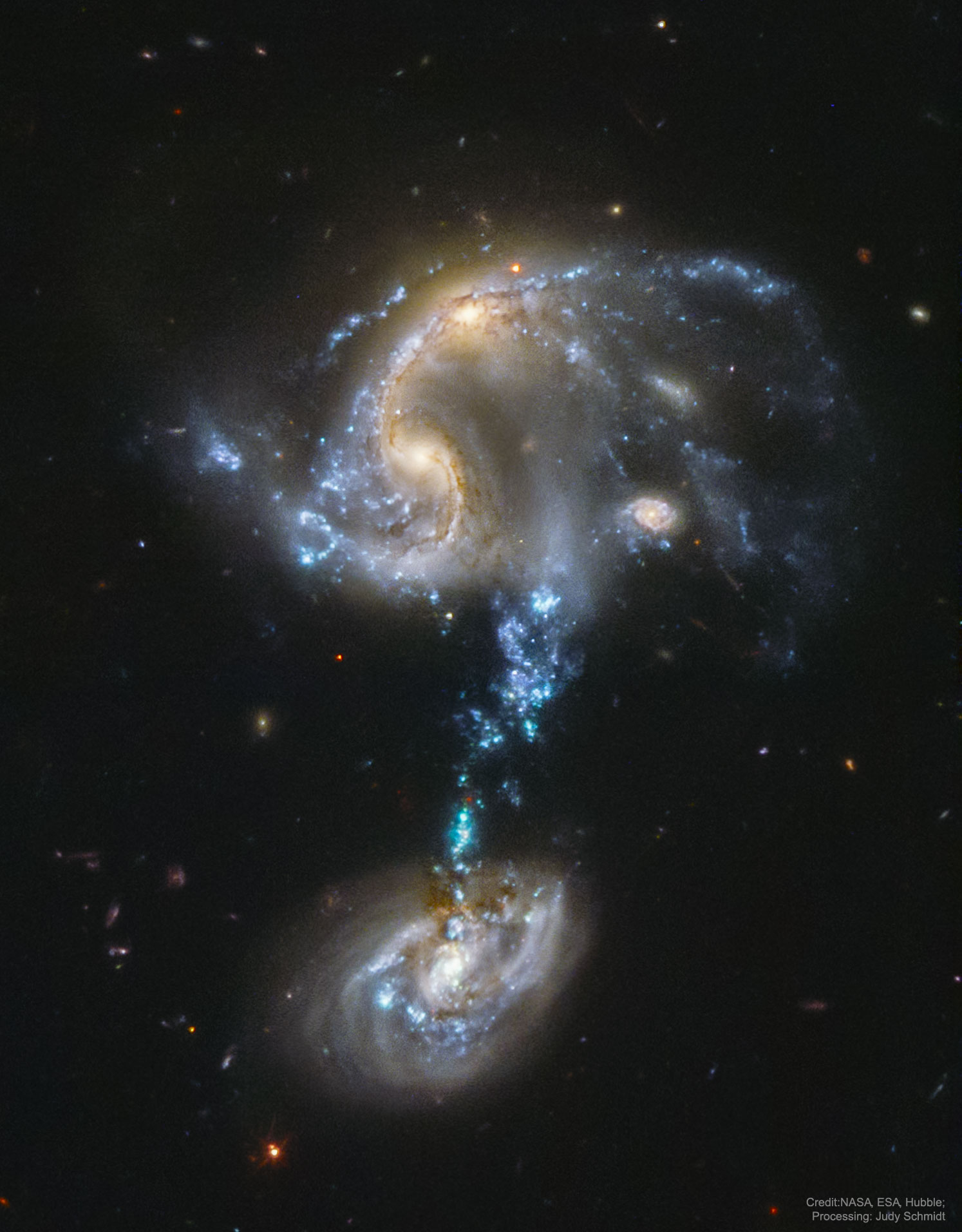 Why are stars forming in the bridge between these colliding galaxies? Usually when galaxies crash, star formation is confined to galaxy disks or tidal tails. In Arp 194, though, there are bright knots of young stars right in a connecting bridge.  Analyses of images and data including the featured image of Arp 194 from Hubble, as well as computer simulations of the interaction, indicate that the bottom galaxy passed right through the top galaxy within the past 100 million years. The result has left a stream of gas that is now falling toward the bottom galaxy. Astronomers hypothesize that stars form in this bridge because of the recent fading of turbulence after the rapid collision. In about a billion years, the galaxies -- including a smaller galaxy superposed on the upper galaxy (see it?) -- will all merge into one larger galaxy.