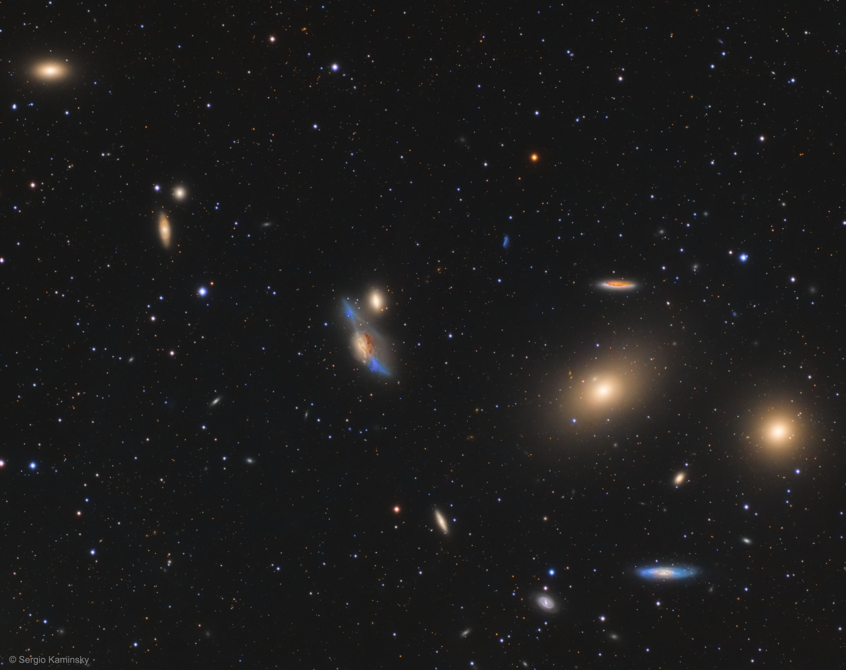 Across the heart of the Virgo Cluster of Galaxies lies a striking string of galaxies known as Markarian's Chain.  The chain, pictured here, is highlighted on the right with two large but featureless lenticular galaxies, M84 and M86. Prominent to their lower left is a pair of interacting galaxies known as The Eyes. The home Virgo Cluster is the nearest cluster of galaxies, contains over 2000 galaxies, and has a noticeable gravitational pull on the galaxies of the Local Group of Galaxies surrounding our Milky Way Galaxy.  The center of the Virgo Cluster is located about 70 million light years away toward the constellation of Virgo.  At least seven galaxies in the chain  appear to move coherently, although others appear to be superposed by chance.    Note: APOD now available in Ukrainian