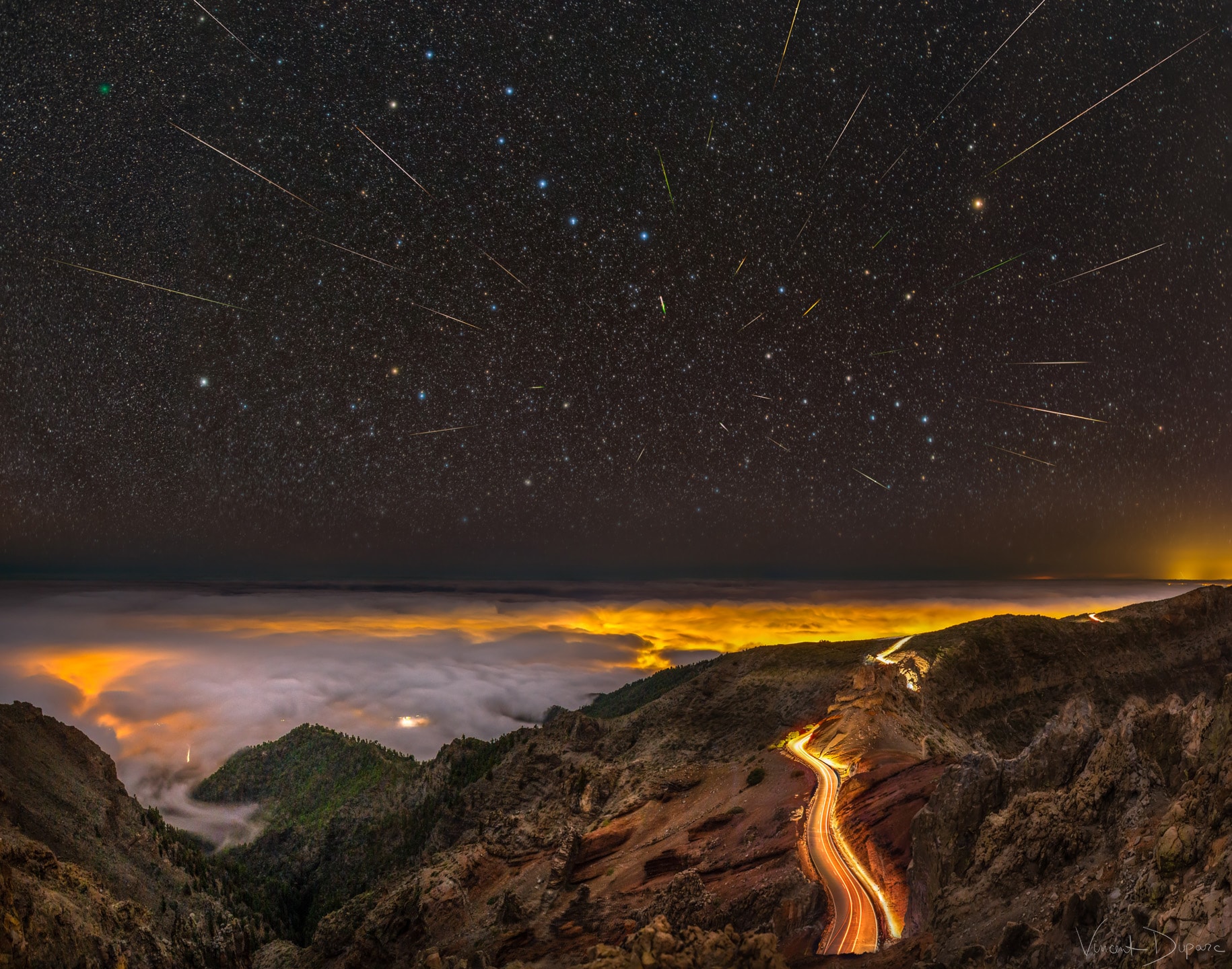 Meteor showers are caused by streams of solid particles, dust size and larger, moving as a group through space.  In most cases, the orbits of these meteor streams can be identified with dust expelled from a comet.  When the Earth passes through a stream, the particles leave brilliant trails through the night sky as they disintegrate in Earth's atmosphere.  The meteor paths are all parallel to each other, but, like train tracks, the effect of perspective causes them to appear to originate from a radiant point in the distance.  The featured image composite was taken during January's Quadrantid meteor shower from La Palma, one of Spain's Canary Islands, off the northwest coast of Africa. The Quadrantids radiant is visible just below the handle of the Big Dipper. A careful eye will also discern the faint green coma of Comet Wirtanen.  Tonight is the peak of the modest Lyrid meteor shower, with several meteors per hour visible from dark locations with clear skies.