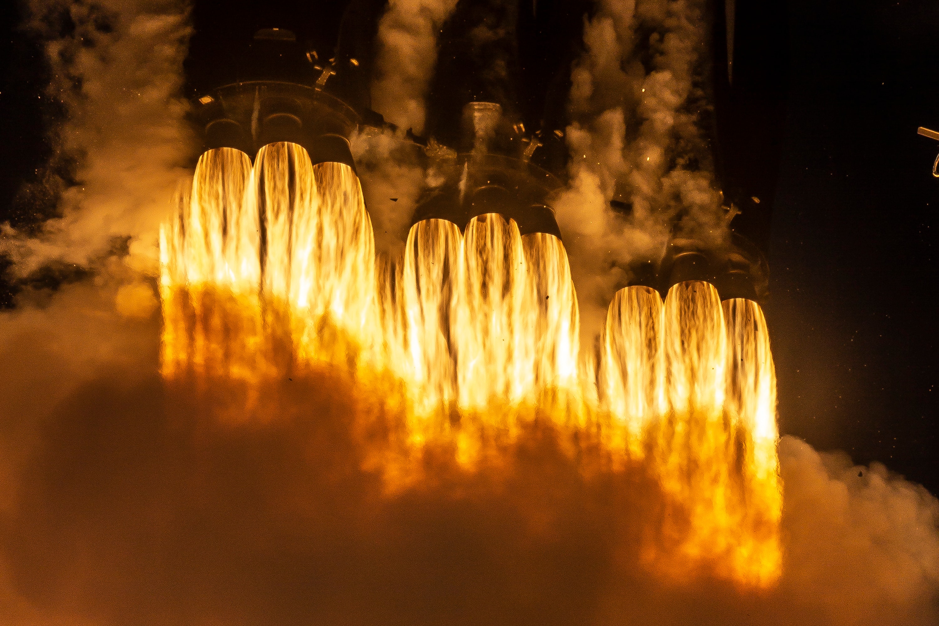 Twenty seven Merlin rocket engines are firing in this close-up of the launch of a Falcon Heavy rocket. Derived from three Falcon 9 first stage rockets with nine Merlin rocket engines each, the Falcon Heavy left NASA's Kennedy Space Center launch pad 39A on April 11. This second launch of a Falcon Heavy rocket carried the Arabsat 6A communications satellite to space. In February of 2018, the first Falcon Heavy launch carried Starman and a Tesla Roadster. Designed to be reusable, both booster stages and the central core returned safely to planet Earth, the boosters to Cape Canaveral Air Force Station landing zones. The core stage landed off shore on autonomous spaceport drone ship Of Course I Still Love You.