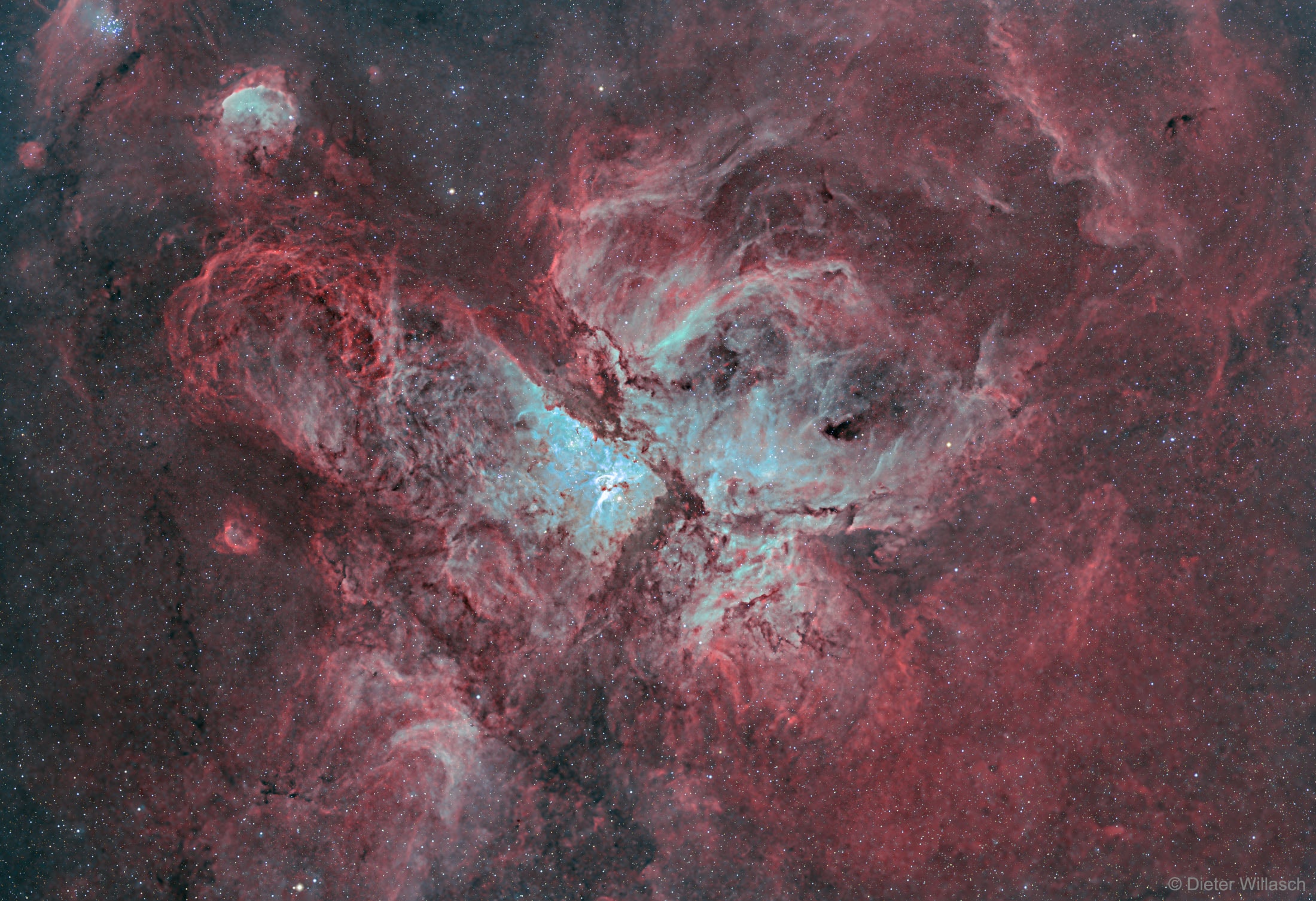 What's happening in the center of the Carina Nebula?  Stars are forming, dying, and leaving an impressive tapestry of dark dusty filaments.  The entire Carina Nebula, cataloged as NGC 3372, spans over 300 light years and lies about 8,500 light-years away in the constellation of Carina. The nebula is composed predominantly of hydrogen gas, which emits the pervasive red glow seen in this highly detailed featured image.  The blue glow in the center is created by a trace amount of glowing oxygen. Young and massive stars located in the nebula's center expel dust when they explode in supernovae.  Eta Carinae, the most energetic star in the nebula's center, was one of the brightest stars in the sky in the 1830s, but then faded dramatically.