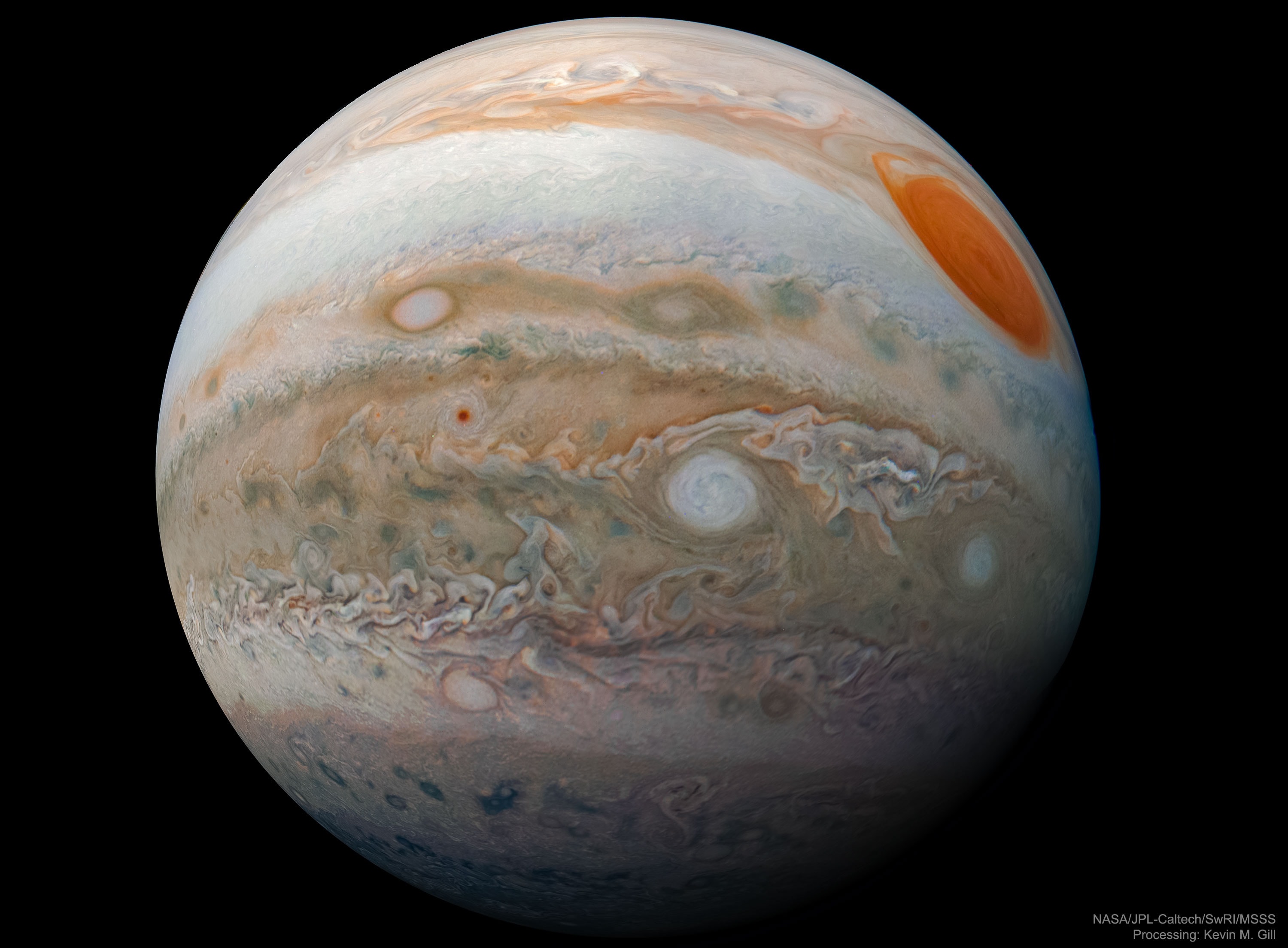 What does Jupiter look like up close? Most images of Jupiter are taken from far away, either from Earth or from a great enough distance that nearly half the planet is visible. This shot, though, was composed from images taken relatively close in, where less than half of the planet was visible.  From here, Jupiter still appears spherical but perspective distortion now makes it look more like a marble. Visible on Jupiter's cloud tops are a prominent dark horizontal belt containing a white oval cloud, and a white zone cloud, both of which circle the planet. The Great Red Spot looms on the upper right. The featured image was taken by the robotic Juno spacecraft in February during its 17th close pass of our Solar System's largest planet.  Juno's mission, now extended into 2021, is to study Jupiter in new ways. Juno's data has already enabled discoveries that include Jupiter's magnetic field being surprisingly lumpy, and that some of Jupiter's cloud systems run about 3,000 kilometers into the planet.