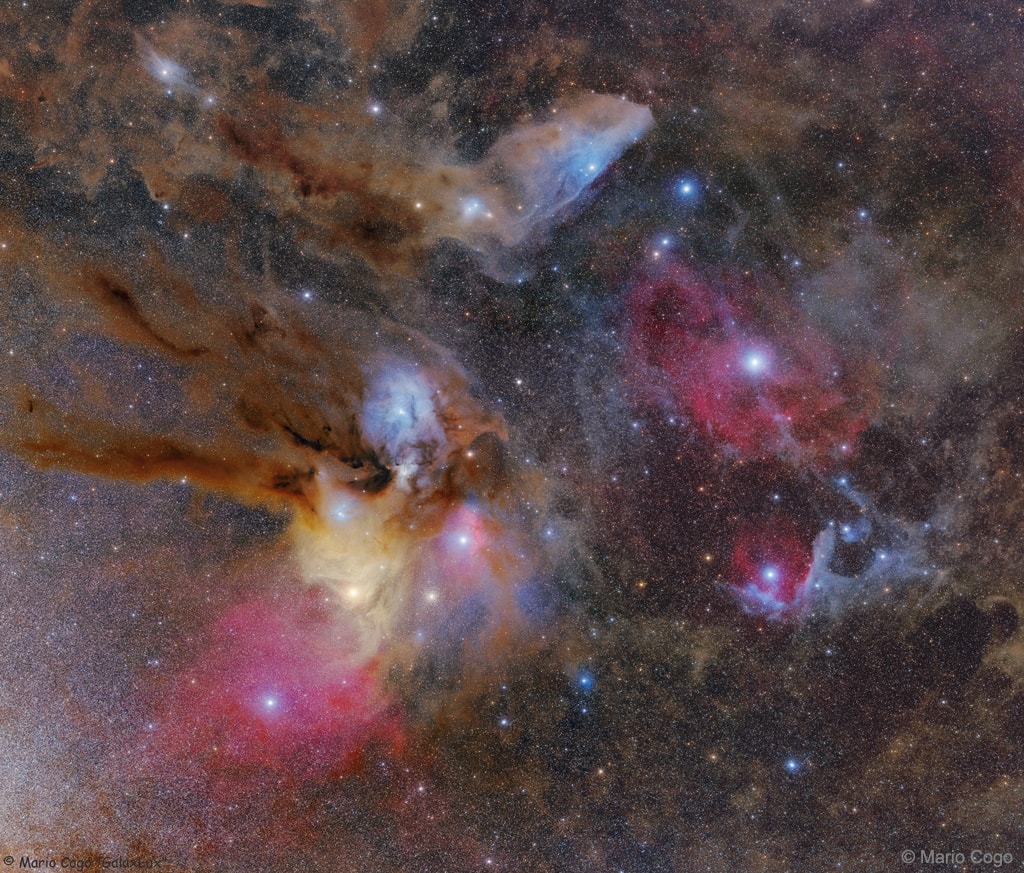 The colorful clouds surrounding the star system Rho Ophiuchi compose one of the closest star forming regions.  Rho Ophiuchi itself is a binary star system visible in the blue reflection nebula just to the left of the image center.  The star system, located only 400 light years away, is distinguished by its multi-colored surroundings, which include a red emission nebula and numerous light and dark brown dust lanes. Near the lower left of the Rho Ophiuchi molecular cloud system is the yellow star Antares, while a distant but coincidently-superposed globular cluster of stars, M4, is visible just to the right of Antares. Near the image top lies IC 4592, the Blue Horsehead nebula.  The blue glow that surrounds the Blue Horsehead's eye -- and other stars around the image -- is a reflection nebula composed of fine dust. On the featured image right is a geometrically angled reflection nebula cataloged as Sharpless 1.  Here, the bright star near the dust vortex creates the light of surrounding reflection nebula. Although most of these features are visible through a small telescope pointed toward the constellations of Ophiuchus, Scorpius, and Sagittarius, the only way to see the intricate details of the dust swirls, as featured above, is to use a long exposure camera.