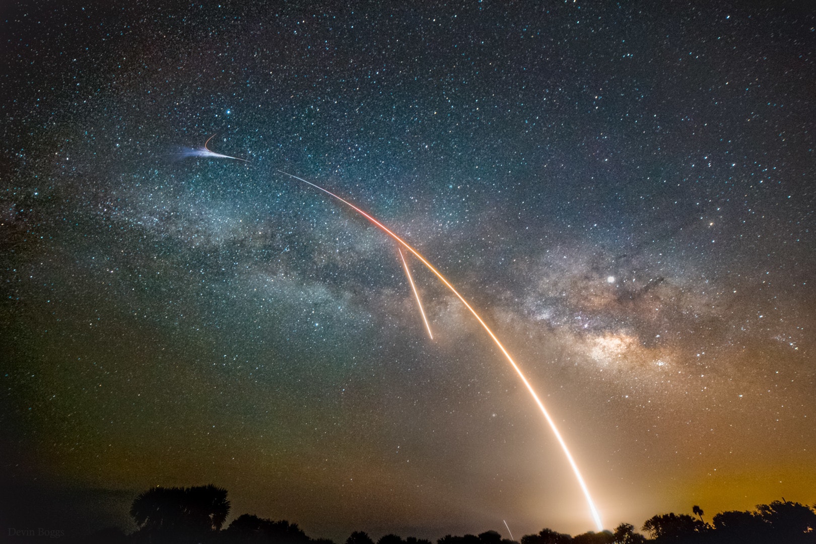 The Milky Way doesn't look quite this colorful and bright to the eye, but a rocket launch does. So a separate deep exposure with a sensitive digital camera was used in this composite skyscape to bring out our galaxy's central crowded starfields and cosmic dust clouds. In the scene from Merritt Island National Wildlife Refuge, a nine minute long exposure begun about 20 minutes after the Miky Way image recorded a rocket launch and landing. The Falcon 9 rocket, named for the Millennium Falcon of Star Wars fame, appropriately launched a Dragon resupply ship to the International Space Station in the early morning hours of May the 4th. The plume and flare at the peak of the launch arc mark the rocket's first stage boost back burn. Two shorter diagonal streaks are the rocket engines bringing the Falcon 9 stage back to an offshore landing on autonomous drone ship Of course I Still Love You.