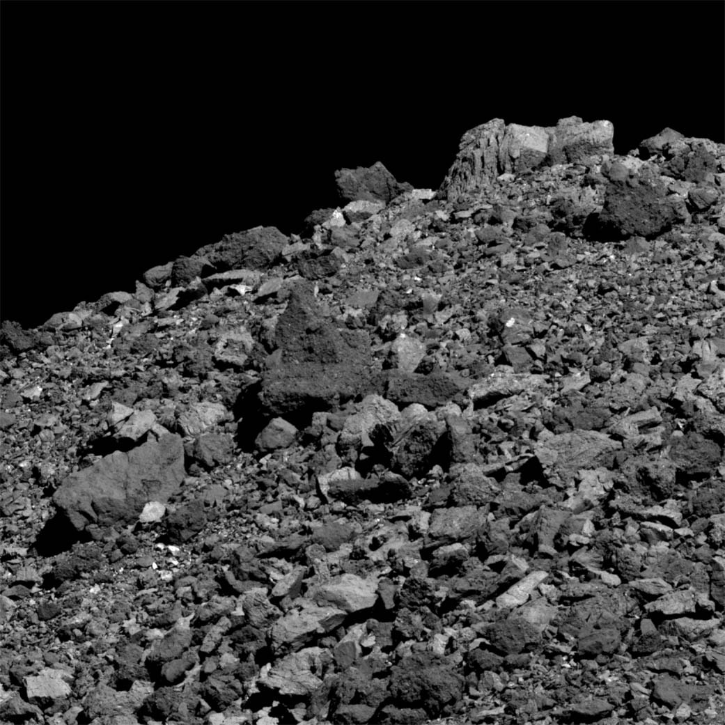 An abundance of boulders litters the surface asteroid 101955 Bennu in this dramatic close-up from the OSIRIS-REx spacecraft. Taken on March 28 from a distance of just 3.4 kilometers (2.1 miles) the field of view is about 50 meters across while the light colored boulder at top right is 4.8 meters tall. Likely a loose conglomerate rubble pile asteroid, Bennu itself spans less than 500 meters. That's about the height of the Empire State Building. Mapping the near Earth asteroid since the spacecraft's arrival in December of 2018, the OSIRIS-REx mission plans a TAG (Touch-and-Go) maneuver for July 2020 to sample Bennu's rugged surface, returning the sample to planet Earth in September 2023. Citizen scientists have been invited to help choose the sample collection site.