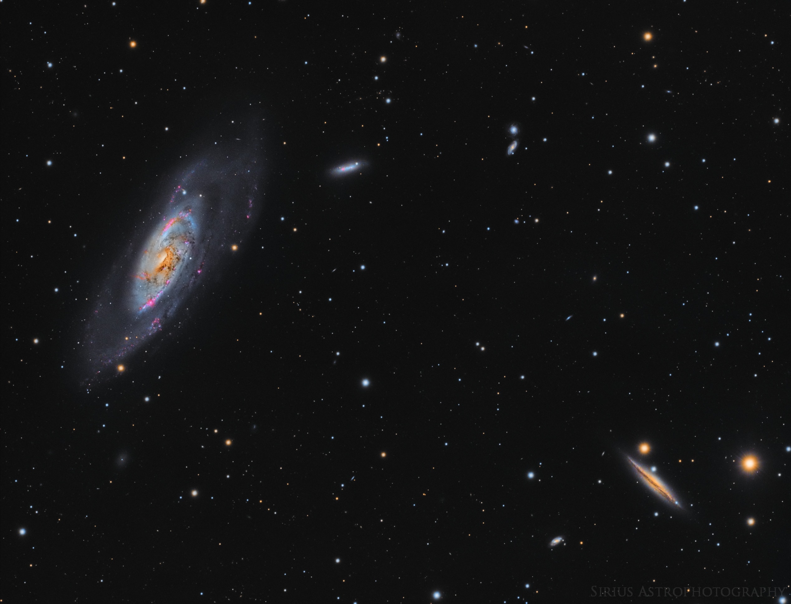 Big, bright, beautiful spiral, Messier 106 dominates this cosmic vista. The nearly two degree wide telescopic field of view looks toward the well-trained constellation Canes Venatici, near the handle of the Big Dipper. Also known as NGC 4258, M106 is about 80,000 light-years across and 23.5 million light-years away, the largest member of the Canes II galaxy group. For a far away galaxy, the distance to M106 is well-known in part because it can be directly measured by tracking this galaxy's remarkable maser, or microwave laser emission. Very rare but naturally occurring, the maser emission is produced by water molecules in molecular clouds orbiting its active galactic nucleus. Another prominent spiral galaxy on the scene, viewed nearly edge-on, is NGC 4217 below and right of M106. The distance to NGC 4217 is much less well-known, estimated to be about 60 million light-years.