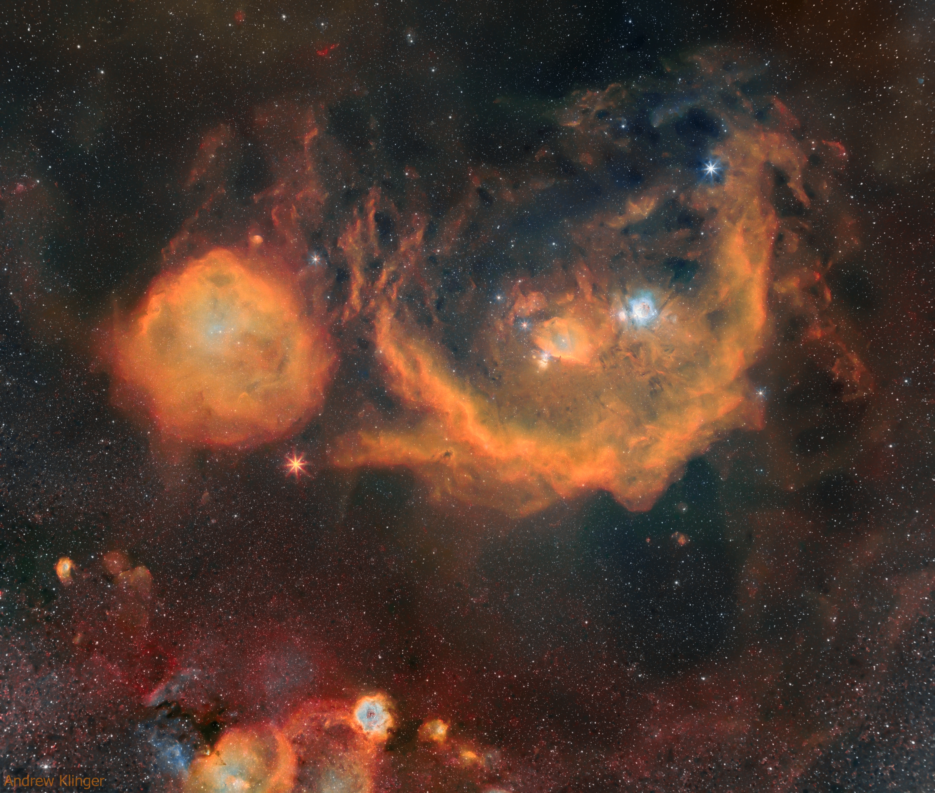 The constellation of Orion is much more than three stars in a row. It is a direction in space that is rich with impressive nebulas. To better appreciate this well-known swath of sky, a new  long exposure image was taken over several clear nights in January, February and March. After 23 hours of camera time and untold hours of image processing, the featured collage in the light of hydrogen, oxygen, and sulfur was produced spanning over 40 times the angular diameter of the Moon.  Of the many interesting details that have become visible, one that particularly draws the eye is Barnard's Loop, the bright red orange arc just to the right of the image center.  The Rosette Nebula is not the giant orange nebula just to the left of the image center -- that is larger but lesser known nebula known as the Meissa Ring.  The Rosette Nebula is visible, though: it is the bright orange, blue and white nebula near the image bottom.  The bright orange star just left of the frame center is Betelgeuse, while the bright blue star on the upper right is Rigel. About those famous three stars that cross the belt of Orion the Hunter -- in this busy frame they can be hard to locate, but a discerning eye will find them just to the right of the image center.
