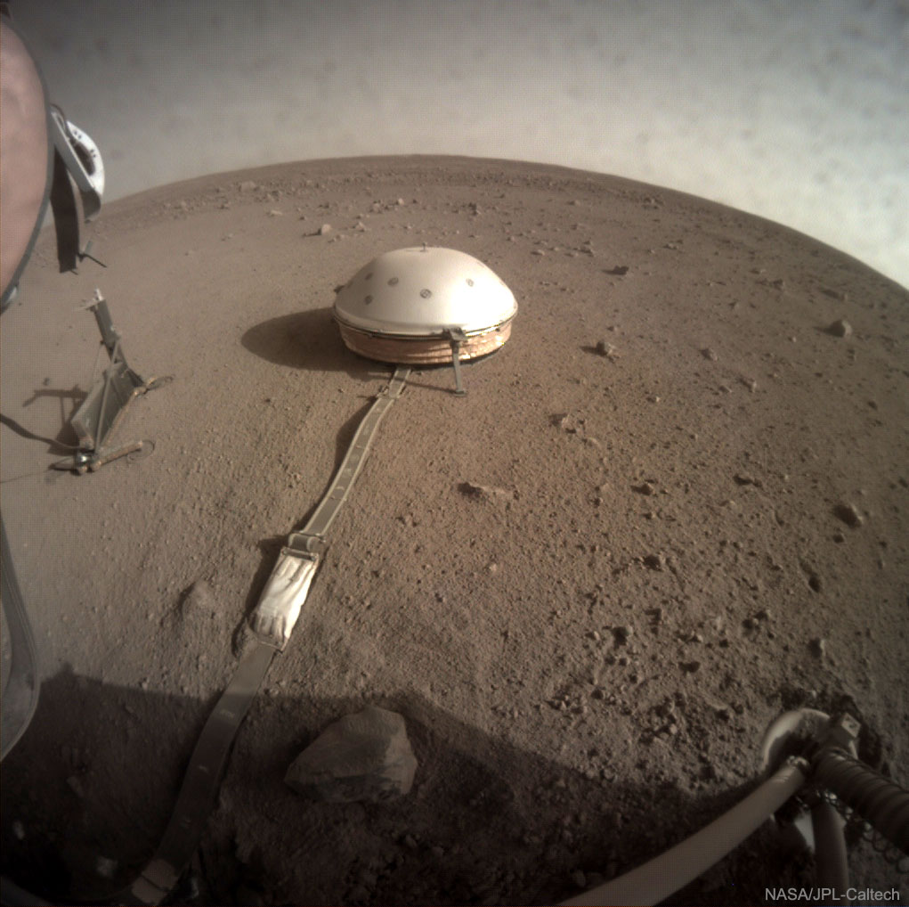 If you put your ear to Mars, what would you hear? To find out, and to explore the unknown interior of Mars, NASA's Insight Lander deployed SEIS late last year, a sensitive seismometer that can detect marsquakes. In early April, after hearing the wind and motions initiated by the lander itself, SEIS recorded an unprecedented event that matches what was expected for a marsquake.  This event can be heard on this YouTube video.  Although Mars is not thought to have tectonic plates like the Earth, numerous faults are visible on the Martian surface which likely occurred as the hot interior of Mars cooled -- and continues to cool.  Were strong enough marsquakes to occur, SEIS could hear their rumbles reflected from large structures internal to Mars, like a liquid core, if one exists.  Pictured last week, SEIS sits quietly on the Martian surface, taking in some Sun while light clouds are visible over the horizon.   Create a Distant Legacy: Send your name to Mars