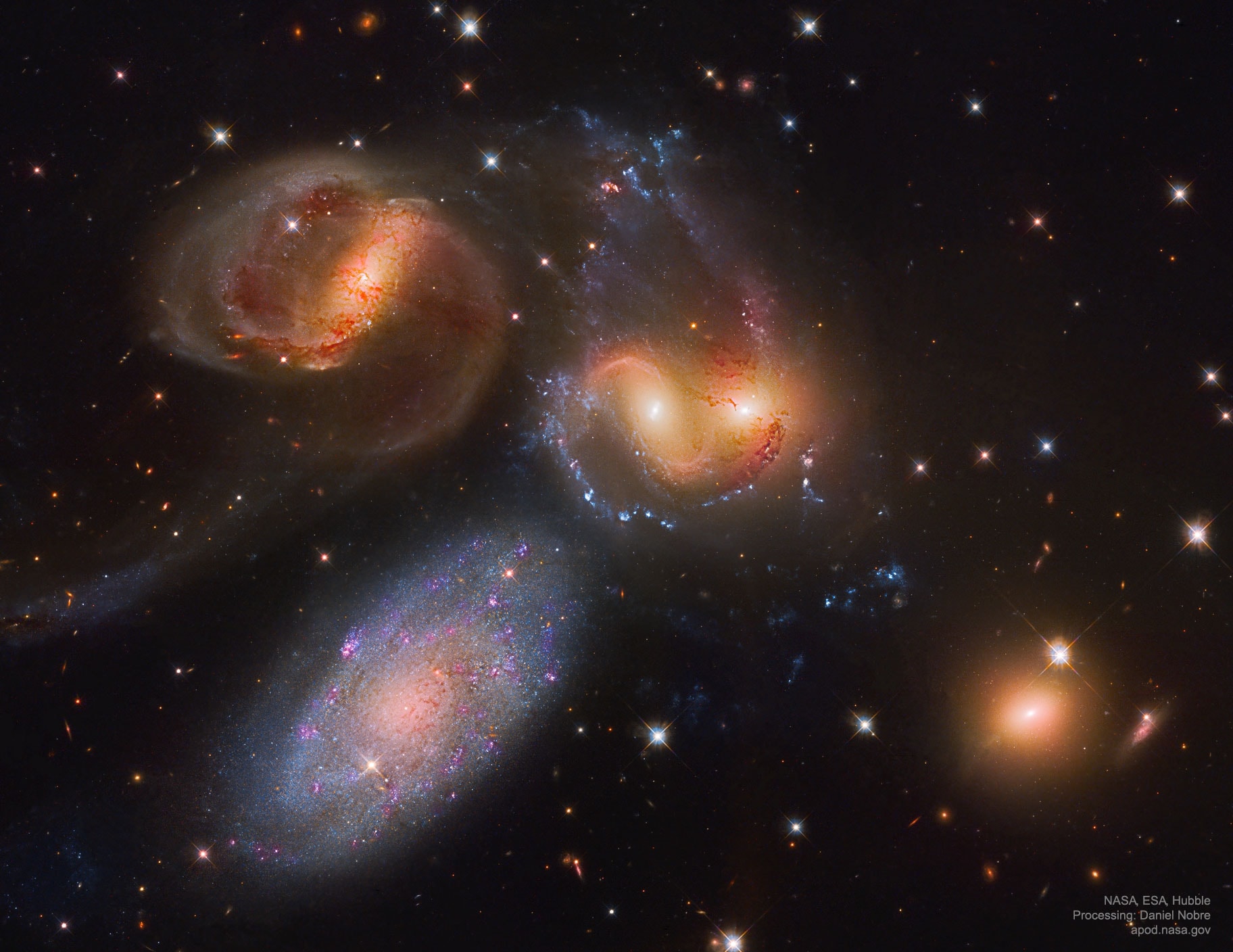When did these big galaxies first begin to dance?  Really only four of the five of Stephan's Quintet are locked in a cosmic tango of repeated close encounters taking place some 300 million light-years away.  The odd galaxy out is easy to spot in this recently reprocessed image by the Hubble Space Telescope -- the interacting galaxies, NGC 7319, 7318B, 7318A, and 7317 (left to right), have a more dominant yellowish cast.  They also tend to have distorted loops and tails, grown under the influence of disruptive gravitational tides.  The mostly bluish galaxy, large NGC 7320 on the lower left, is in the foreground at about 40 million light-years distant, and so is not part of the interacting group. Data and modeling indicate that NGC 7318B is a relatively new intruder. A recently-discovered halo of old red stars surrounding Stephan's Quintet indicate that at least some of these galaxies started tangling over a billion years. Stephan's Quintet is visible with a moderate sized-telescope toward the constellation of Winged Horse (Pegasus).