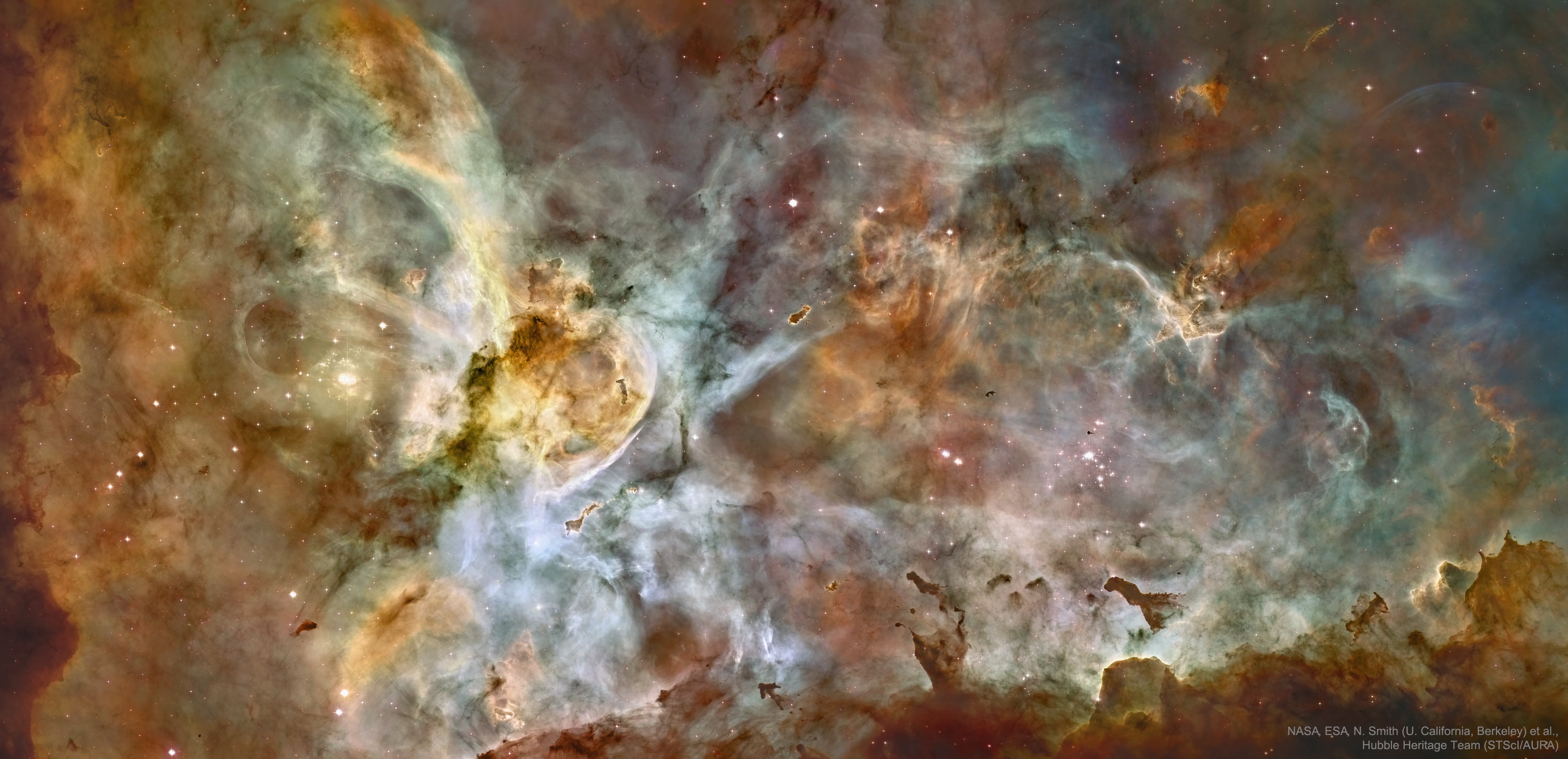 How do violent stars affect their surroundings? To help find out, astronomers created a 48-frame high-resolution, controlled-color panorama of the center of the Carina Nebula, one of the largest star forming regions on the night sky. The featured image, taken in 2007, was the most detailed image of the Carina Nebula yet taken.  Cataloged as NGC 3372, the Carina Nebula is home to streams of hot gas, pools of cool gas, knots of dark globules, and pillars of dense dusty interstellar matter. The Keyhole Nebula, visible left of center, houses several of the most massive stars known.  These large and violent stars likely formed in dark globules and continually reshape the nebula with their energetic light, outflowing stellar winds, and ultimately by ending their lives in supernova explosions.  Visible to the unaided eye, the entire Carina Nebula spans over 450 light years and lies about 8,500 light-years away toward the constellation of Ship's Keel (Carina).