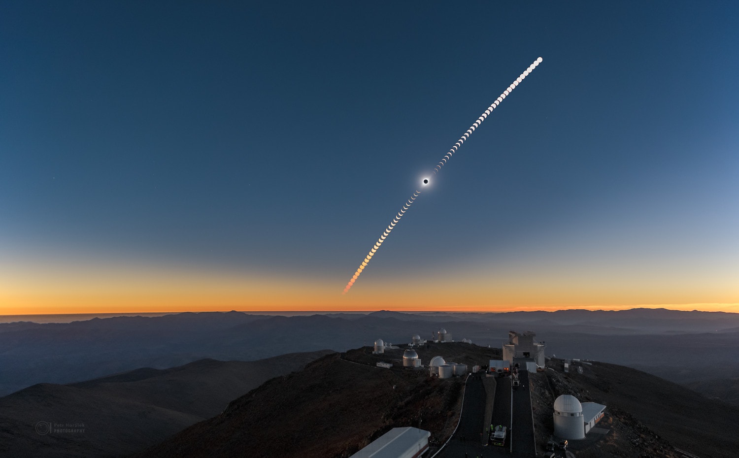 The road to the high mountaintop La Silla Observatory in the Chilean Atacama Desert also led in to the path of July 2nd's total solar eclipse. Recorded at regular intervals before and after the total eclipse phase, the frames in this composite sequence include the moment the Moon's dark shadow fell across some of planet Earth's advanced large telescopes. The dreamlike view looks west toward the setting Sun and the approaching Moon shadow. In fact La Silla was a little north of the shadow track's center line, so the region's stunning, clear skies are slightly brighter to the north (right) in the scene.