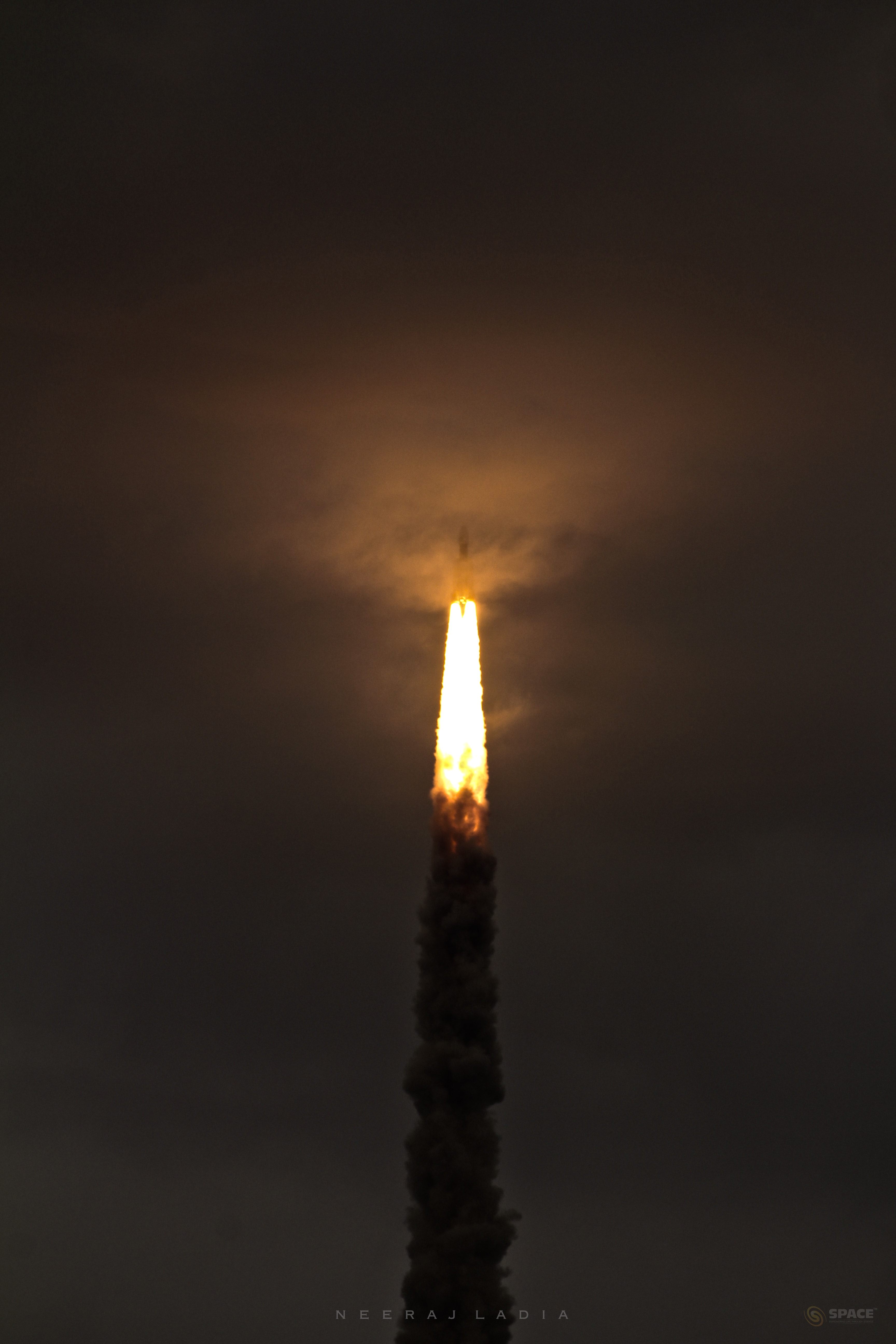 On July 22nd this GSLV (Geosynchronous Satellite Launch Vehicle) MkIII rocket vanished from sight into a cloud bank an instant after this dramatic snapshot was taken. Launched from India's Satish Dhawan Space Centre it carried the Chandrayaan 2 mission spacecraft into Earth orbit. The spacecraft's orbiter, lander, and rover are destined for the Moon, though. In the coming weeks it will perform a series of orbit raising maneuvers, eventually transferring to lunar orbit in early September. Carrying the solar-powered rover, the lander is scheduled to separate and attempt its autonomous soft landing at high latitudes near the lunar south pole. It should arrive on the lunar nearside near local sunrise and the start of about two Earth weeks of lunar daylight on September 7.