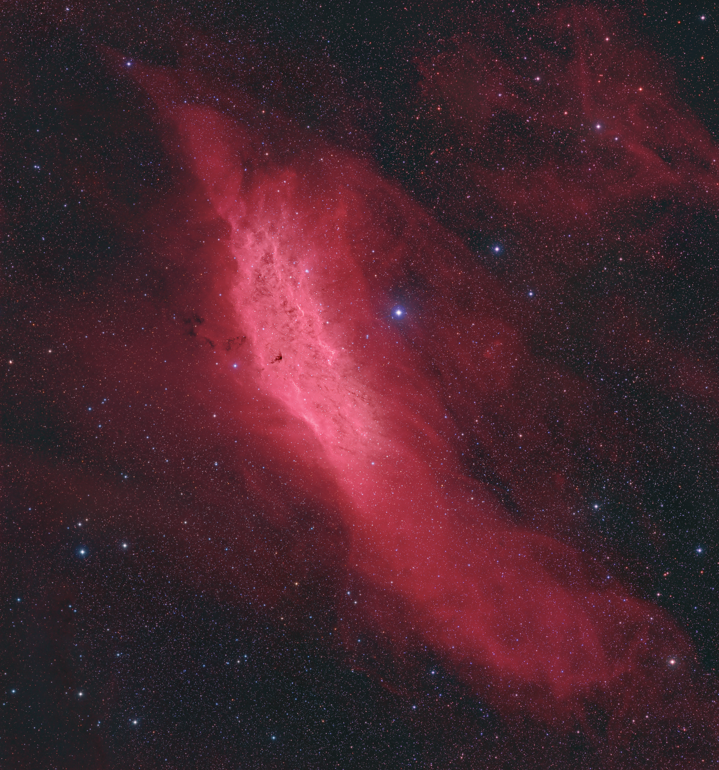 Drifting through the Orion Arm of the spiral Milky Way Galaxy, this cosmic cloud by chance echoes the outline of California on the west coast of the United States. Our own Sun also lies within the Milky Way's Orion Arm, only about 1,500 light-years from the California Nebula. Also known as NGC 1499, the classic emission nebula is around 100 light-years long. The California Nebula shines with the telltale reddish glow characteristic of hydrogen atoms recombining with long lost electrons. The electrons have been stripped away, ionized by energetic starlight. Most likely providing the energetic starlight that ionizes much of the nebular gas is the bright, hot, bluish star Xi Persei just to the right of the nebula.  A popular target for astrophotographers, this deep California Nebula image is a 6 panel telecopic mosaic and covers a wide field of view. The nebula lies toward the constellation Perseus, not far from the Pleiades.