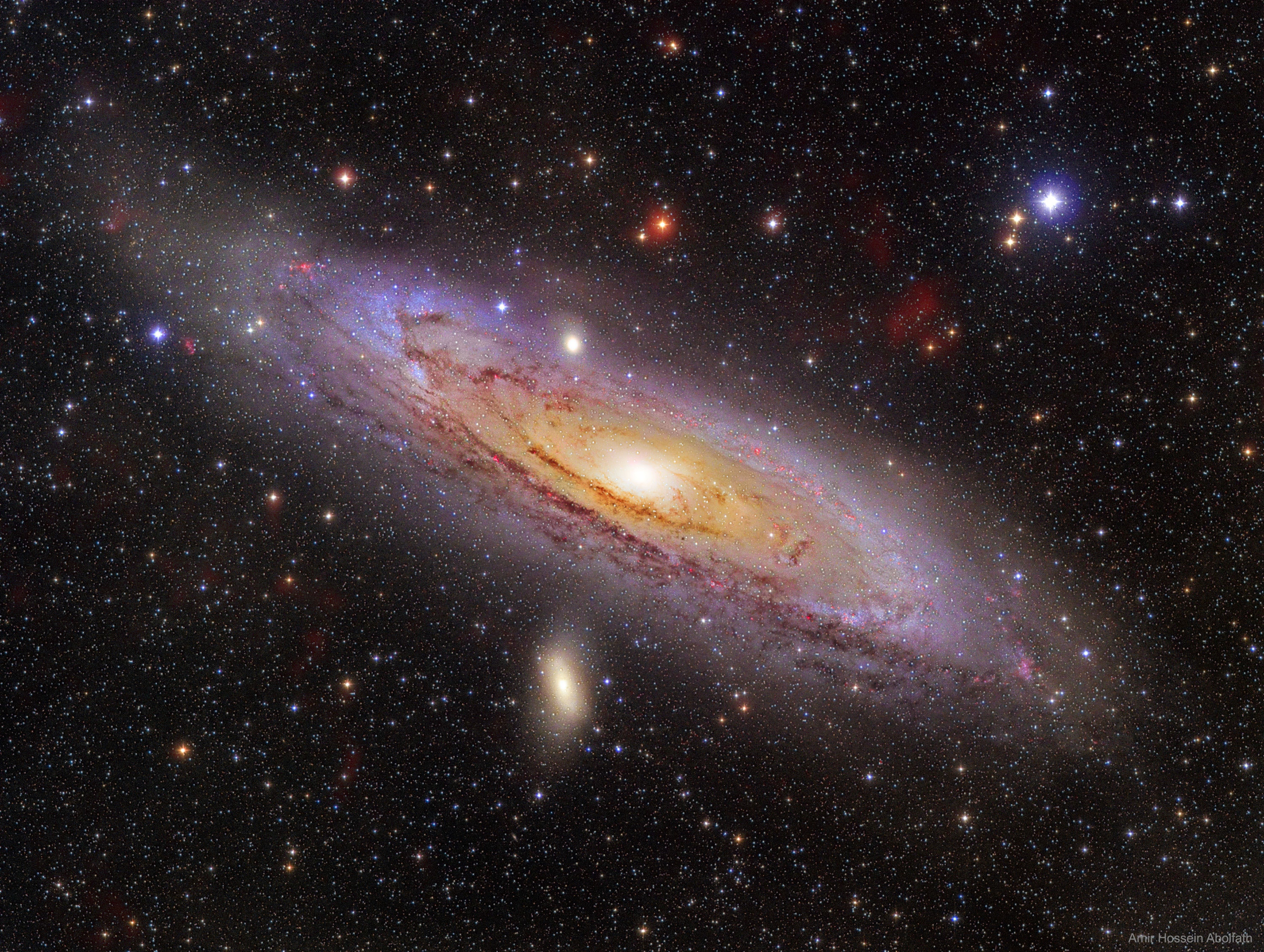 How far can you see? The most distant object easily visible to the unaided eye is M31, the great Andromeda Galaxy, over two million light-years away.  Without a telescope, even this immense spiral galaxy appears as an unremarkable, faint, nebulous cloud in the constellation Andromeda.  But a bright yellow nucleus, dark winding dust lanes, luminous blue spiral arms, and bright red emission nebulas are recorded in this stunning six-hour telescopic digital mosaic of our closest major galactic neighbor.  While even casual skygazers are now inspired by the knowledge that there are many distant galaxies like M31, astronomers seriously debated this fundamental concept only 100 years ago.  Were these "spiral nebulae" simply outlying gas clouds in our own Milky Way Galaxy or were they "island universes" -- distant galaxies of stars comparable to the Milky Way itself?  This question was central to the famous Shapley-Curtis debate of 1920, which was later resolved by observations favoring Andromeda being just like our Milky Way Galaxy -- a conclusion making the rest of the universe much more vast than many had ever imagined.