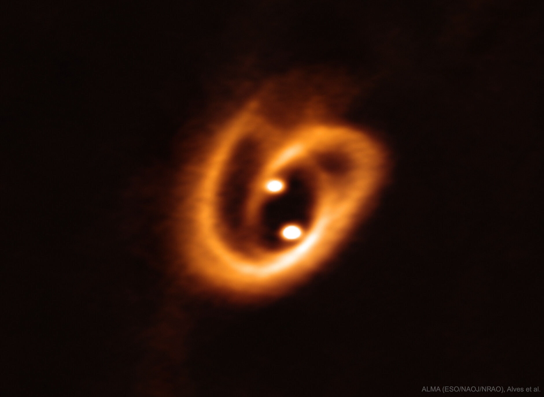 How do binary stars form? To help find out, the Atacama Large Millimeter Array (ALMA) recently captured one of the highest resolution images yet taken of a binary star system in formation.  Most stars are not alone -- they typically form as part of a multiple star systems where star each orbits a common center of gravity.  The two bright spots in the featured image are small disks that surround the forming proto-stars in [BHB2007] 11, while the surrounding pretzel-shaped filaments are gas and dust that have been gravitationally pulled from a larger disk.  The circumstellar filaments span roughly the radius of the orbit of Neptune.  The BHB2007 system is a small part of the Pipe Nebula (also known as Barnard 59), a photogenic network of dust and gas that protrudes from Milky Way's spiral disk in the constellation of Ophiuchus. The binary star formation process should be complete within a few million years.