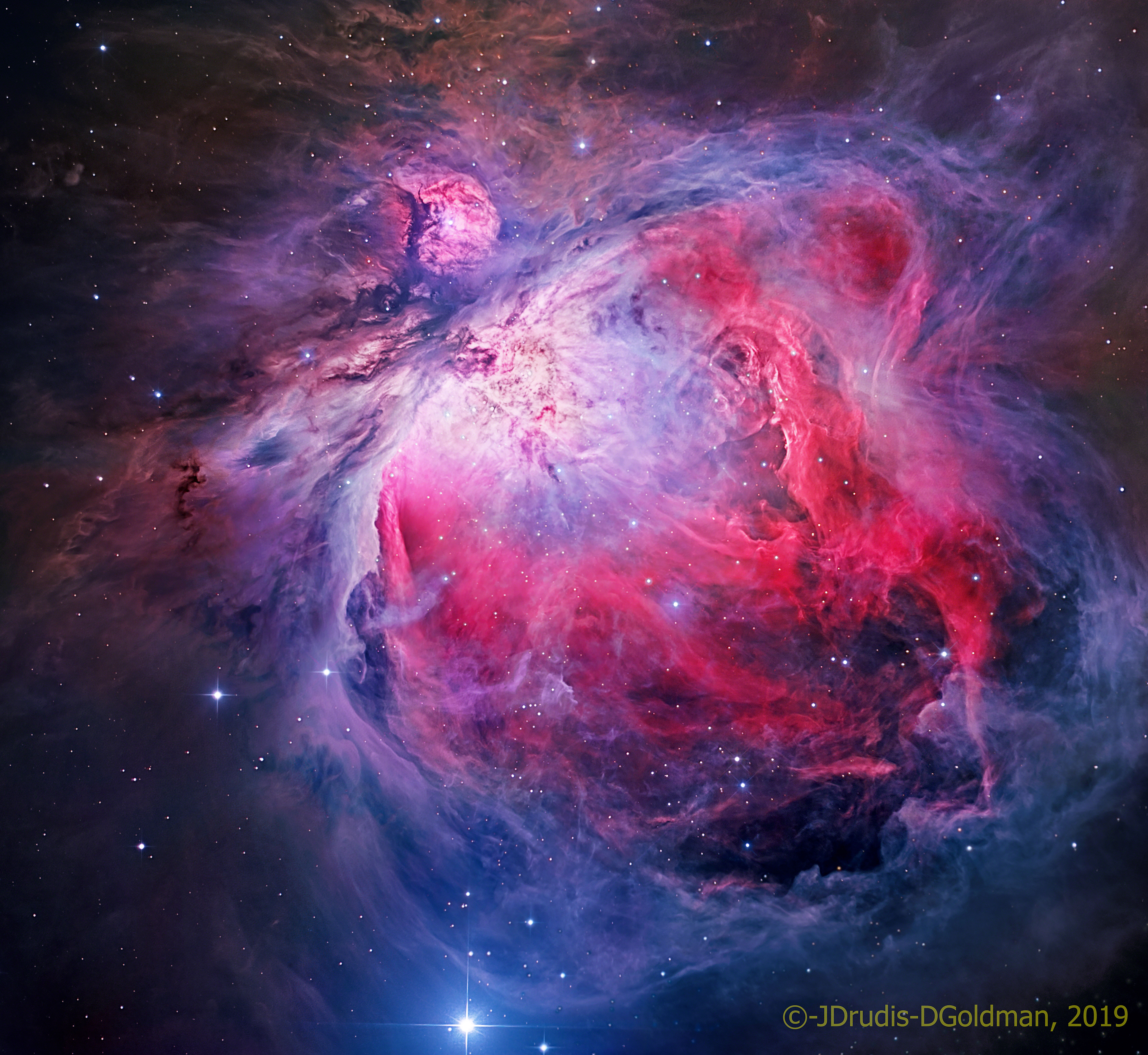 The Great Nebula in Orion, an immense, nearby starbirth region, is probably the most famous of all astronomical nebulas. Here, glowing gas surrounds hot young stars at the edge of an immense interstellar molecular cloud only 1500 light-years away. In the featured deep image in assigned colors highlighted by emission in oxygen and hydrogen, wisps and sheets of dust and gas are particularly evident. The Great Nebula in Orion can be found with the unaided eye near the easily identifiable belt of three stars in the popular constellation Orion. In addition to housing a bright open cluster of stars known as the Trapezium, the Orion Nebula contains many stellar nurseries. These nurseries contain much hydrogen gas, hot young stars, proplyds, and stellar jets spewing material at high speeds. Also known as M42, the Orion Nebula spans about 40 light years and is located in the same spiral arm of our Galaxy as the Sun.