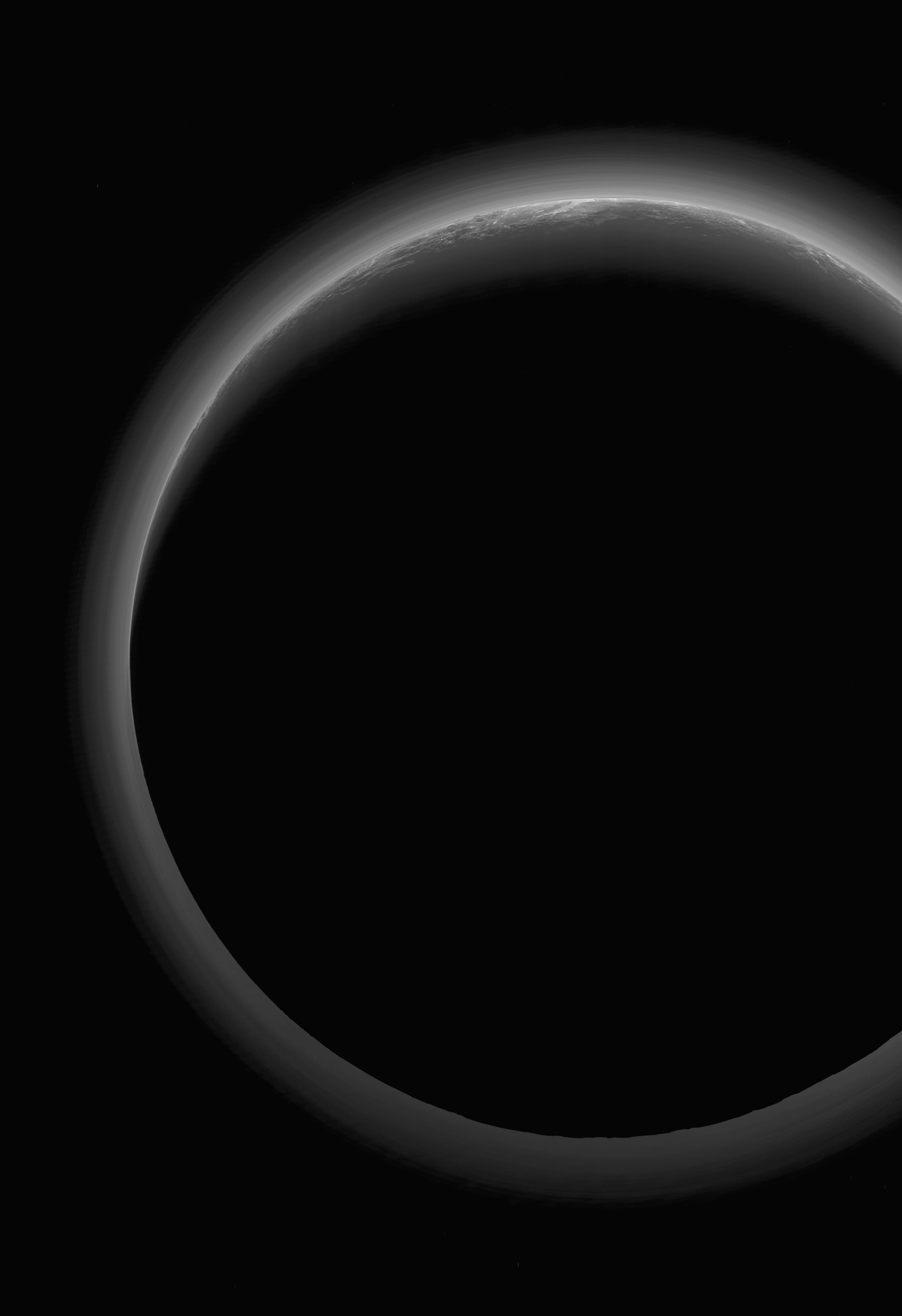 The night side of Pluto spans this shadowy scene, a stunning spacebased view with the Sun 4.9 billion kilometers (almost 4.5 light-hours) behind the dim and distant world. It was captured by far flung New Horizons in July of 2015. The spacecraft was at a range of some 21,000 kilometers from Pluto, about 19 minutes after its closest approach. A denizen of the Kuiper Belt in dramatic silhouette, the image also reveals Pluto's tenuous, surprisingly complex layers of hazy atmosphere. The crescent twilight landscape near the top of the frame includes southern areas of nitrogen ice plains now formally known as Sputnik Planitia and rugged mountains of water-ice in the Norgay Montes.