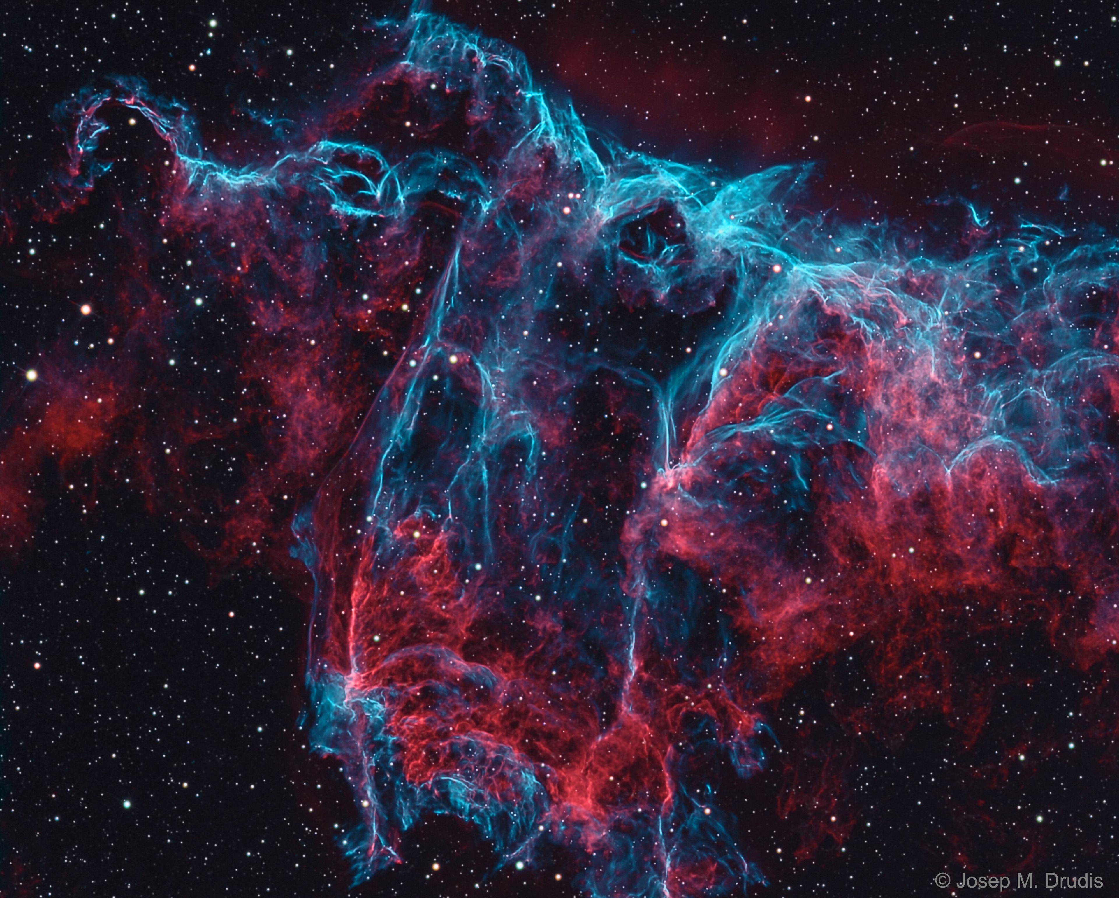 Do you see the bat?  It haunts this cosmic close-up of the eastern Veil Nebula.  The Veil Nebula itself is a large supernova remnant, the expanding debris cloud from the death explosion of a massive star. While the Veil is roughly circular in shape and covers nearly 3 degrees on the sky toward the constellation of the Swan (Cygnus), the Bat Nebula, NGC 6995, spans only 1/2 degree, about the apparent size of the Moon. That translates to 12 light-years at the Veil's estimated distance, a reassuring 1,400 light-years from planet Earth. In the composite of image data recorded through broad and narrow band filters, emission from hydrogen atoms in the remnant is shown in red with strong emission from oxygen and nitrogen atoms shown in hues of blue. Of course, in the western part of the Veil lies another seasonal apparition: the Witch's Broom Nebula.