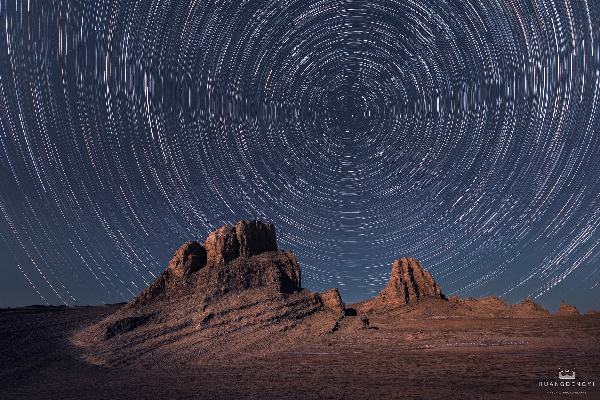 Does Mars have a north star? In long exposures of Earth's night sky, star trails make concentric arcs around the north celestial pole, the direction of our fair planet's axis of rotation. Bright star Polaris is presently the Earth's North Star, close on the sky to Earth's north celestial pole. But long exposures on Mars show star trails too, concentric arcs about a celestial pole determined by Mars' axis of rotation. Tilted like planet Earth's, the martian axis of rotation points in a different direction in space though. It points to a place on the sky between stars in Cygnus and Cepheus with no bright star comparable to Earth's north star Polaris nearby. So even though this ruddy, weathered landscape is remarkably reminiscent of terrain in images from the  martian surface, the view must be from planet Earth, with north star Polaris near the center of concentric star trails. The landforms in the foreground are found in Qinghai Province in northwestern China.