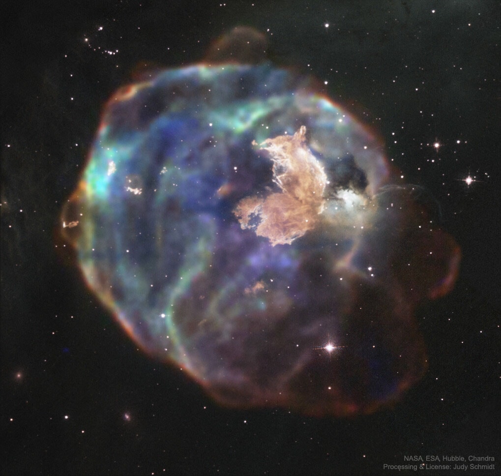 What has this supernova left behind?  As little as 2,000 years ago, light from a massive stellar explosion in the Large Magellanic Cloud (LMC) first reached planet Earth. The LMC is a close galactic neighbor of our Milky Way Galaxy and the rampaging explosion front is now seen moving out - destroying or displacing ambient gas clouds while leaving behind relatively dense knots of gas and dust.  What remains is one of the largest supernova remnants in the LMC: N63A.  Many of the surviving dense knots have been themselves compressed and may further contract to form new stars.  Some of the resulting stars may then explode in a supernova, continuing the cycle.  Featured here is a combined image of N63A in the X-ray from the Chandra Space Telescope and in visible light by Hubble.  The prominent knot of gas and dust on the upper right -- informally dubbed the Firefox -- is very bright in visible light, while the larger supernova remnant shines most brightly in X-rays.  N63A spans over 25 light years and lies about 150,000 light years away toward the southern constellation of Dorado.