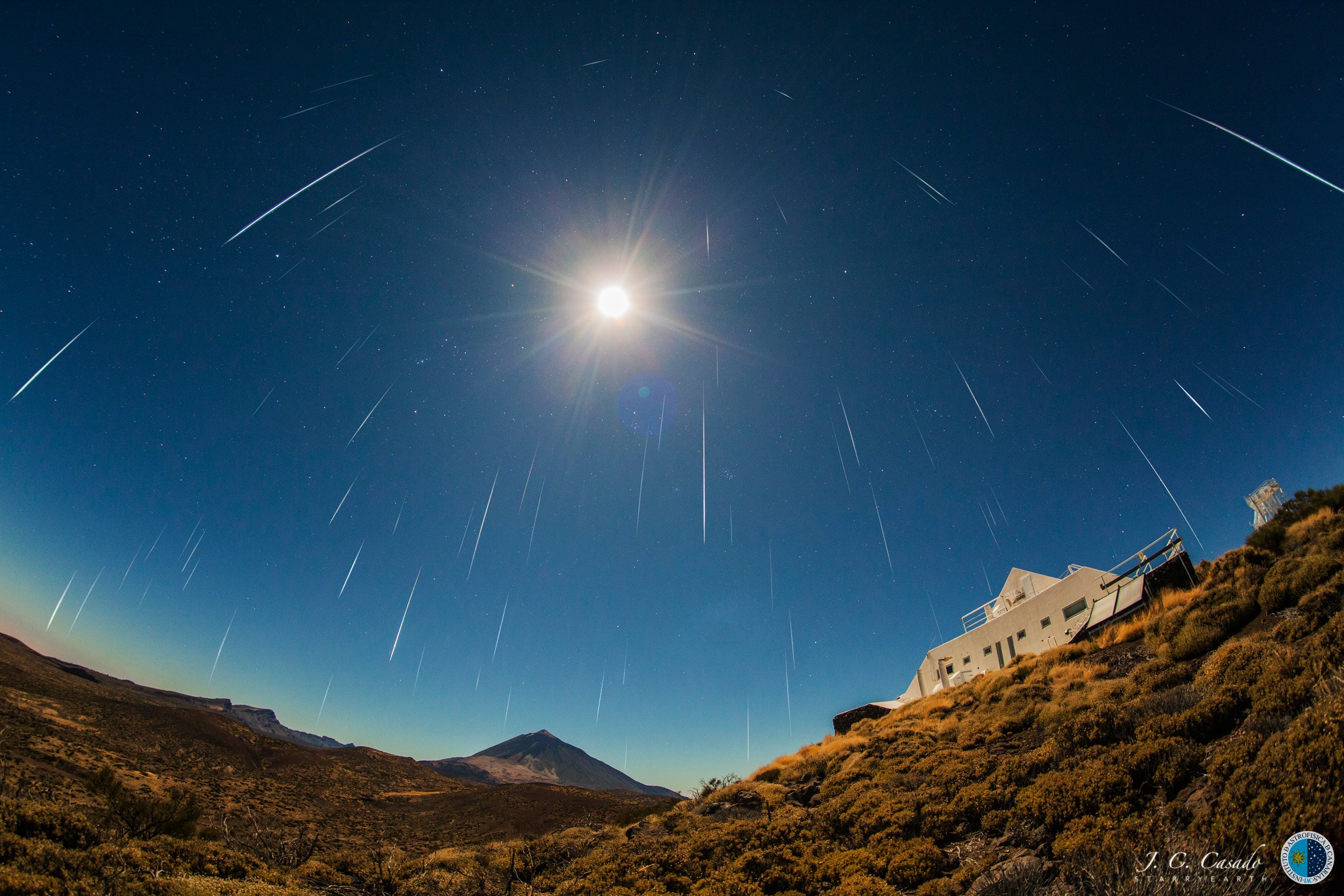 The dependable annual Geminid meteor shower will be near its peak tonight (December 13/14) and before tomorrow's dawn. As Earth crosses through the dusty trail of active asteroid 3200 Phaethon the meteors will flash through the sky from the shower's radiant in Gemini. Gemini will be pretty easy for skygazers to find too as it won't be far from a nearly full waning gibbous Moon. You don't have look at the shower's radiant to see meteors though. The almost full moonlight won't hide the brightest of the Geminids from view either, but it will substantially reduce the rate of visible meteors for those who are counting. In fact, the 2019 Geminids should look a lot like the 2016 meteor shower. This composite image from the 2016 Geminids aligns individual short exposures to capture many of the brighter Geminid meteors, inspite of a Full Moon shining near the constellation of the Twins. Along the horizon are the Teide Observatory's Solar Laboratory (right) and the Teide volcano on the Canary Island of Tenerife.