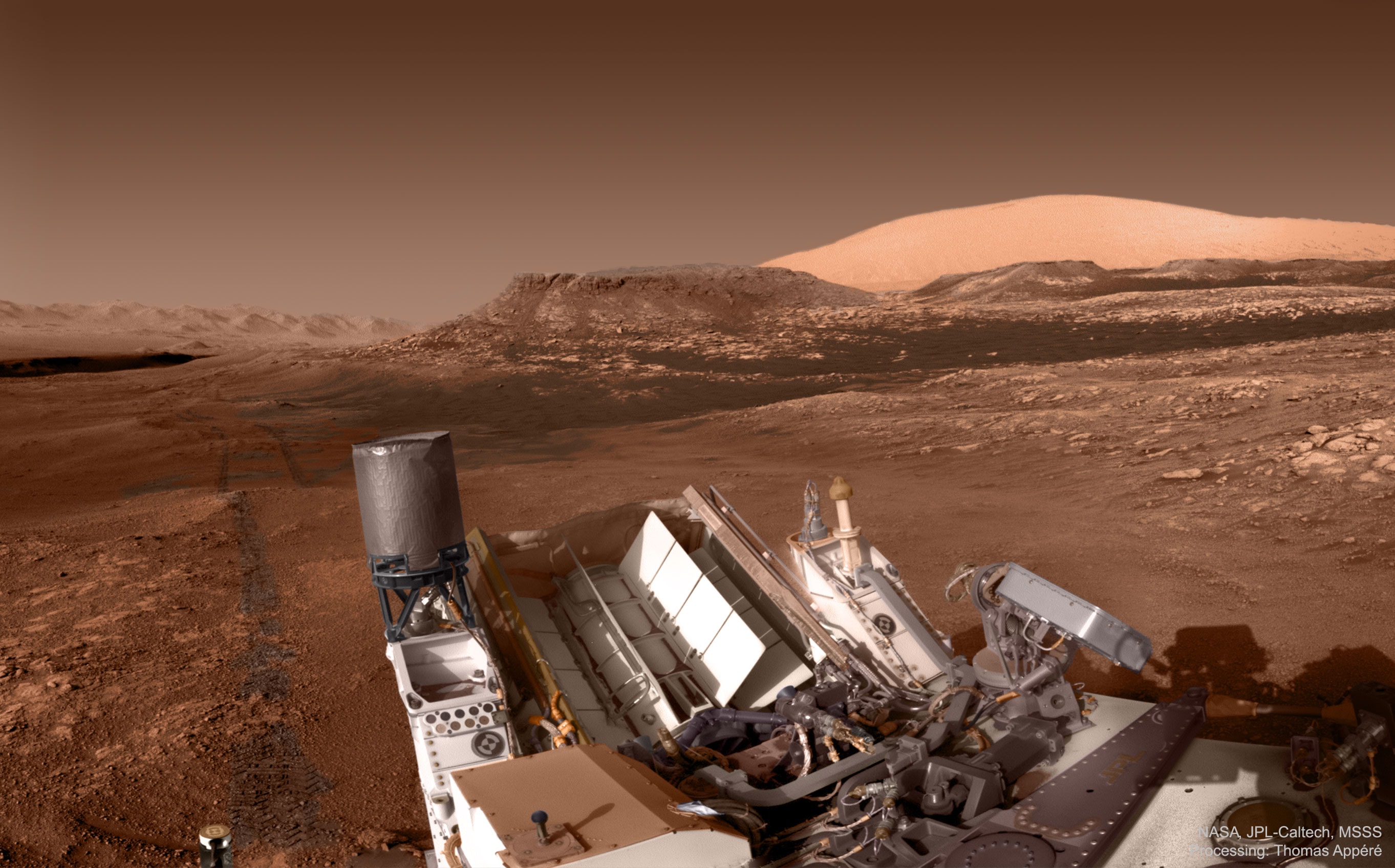 Sometimes, even rovers on Mars stop to admire the scenery. Just late last November the Curiosity rover on Mars paused to photograph its impressive surroundings. One thing to admire, straight ahead, was Central Butte, an unusual flat hill studied by Curiosity just a few days before this image was taken. To its right was distant Mount Sharp, the five-kilometer central peak of entire Gale crater, the interior of which Curiosity is exploring. Mount Sharp, covered in sulfates, appears quite bright in this colorized, red-filtered image. To the far left, shrouded in a very dark shadow, was the south slope of Vera Rubin ridge, an elevation explored previously by Curiosity.  Between the ridge and butte were tracks left by Curiosity's wheels as they rolled forward, out of the scene. In the image foreground is, of course, humanity's current eyes on Mars: the complex robotic rover Curiosity itself.  Later this year, if all goes well, NASA will have another rover -- and more eyes -- on Mars. Today you can help determine the name of this rover yourself, but tomorrow is the last day to cast your vote.   Help Name the Mars 2020 Rover: Vote here!