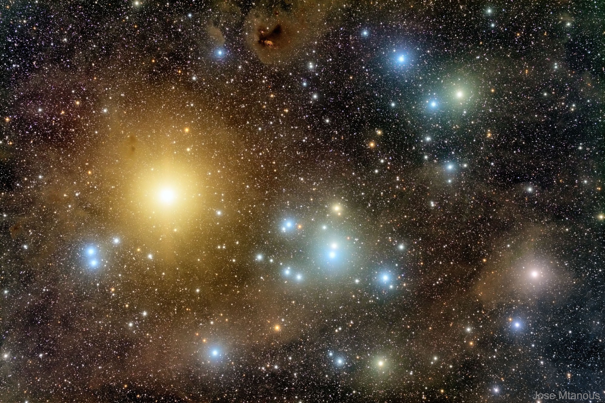 It is the closest cluster of stars to the Sun. The Hyades open cluster is bright enough to have been remarked on even thousands of years ago, yet is not as bright or compact as the nearby Pleiades (M45) star cluster. Pictured here is a particularly deep image of the Hyades which has brings out vivid star colors and faint coincidental nebulas.  The brightest star in the field is yellow Aldebaran, the eye of the bull toward the constellation of Taurus. Aldebaran, at 65 light-years away, is now known to be unrelated to the Hyades cluster, which lies about 150 light-years away.  The central Hyades stars are spread out over about 15 light-years. Formed about 625 million years ago, the Hyades likely shares a common origin with the Beehive cluster (M44), a naked-eye open star cluster toward the constellation of Cancer, based on M44's motion through space and remarkably similar age.