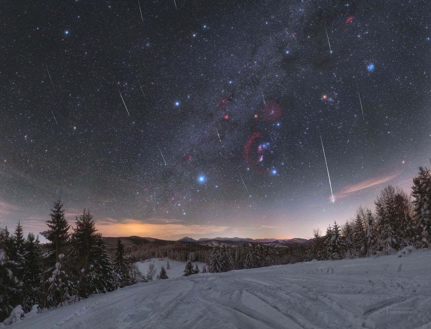 Why are these meteor trails nearly parallel? Because they were all shed by the same space rock and so can be traced back to the same direction on the sky: the radiant of the Quadrantid Meteor Shower.  This direction used to be toward the old constellation of Quadrans Muralis, hence the name Quadrantids, but when the International Astronomical Union formulated its list of modern constellations in 1922, this constellation did not make the list. Even though the meteors are now considered to originate from the recognized constellation of Bootes, the old name stuck. Regardless of the designation, every January the Earth moves through a dust stream and bits of this dust glow as meteors as they heat up in Earth's atmosphere.  The featured image composite was taken on January 4 with a picturesque snowy Slovakian landscape in the foreground, and a deep-exposure sky prominently featuring the constellation Orion in the background. The red star Betelgeuse appears unusually dim -- its fading over the past few months is being tracked by astronomers.   Teachers: APOD in the Classroom