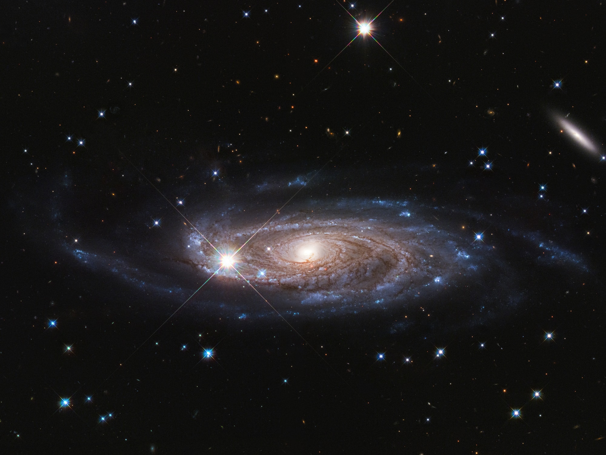 In this Hubble Space Telescope image the bright, spiky stars lie in the foreground toward the heroic northern constellation Perseus and well within our own Milky Way galaxy. In sharp focus beyond is UGC 2885, a giant spiral galaxy about 232 million light-years distant. Some 800,000 light-years across compared to the Milky Way's diameter of 100,000 light-years or so, it has around 1 trillion stars. That's about 10 times as many stars as the Milky Way. Part of a current investigation to understand how galaxies can grow to such enormous sizes, UGC 2885 was also part of astronomer Vera Rubin's pioneering study of the rotation of spiral galaxies. Her work was the first to convincingly demonstrate the dominating presence of dark matter in our universe.