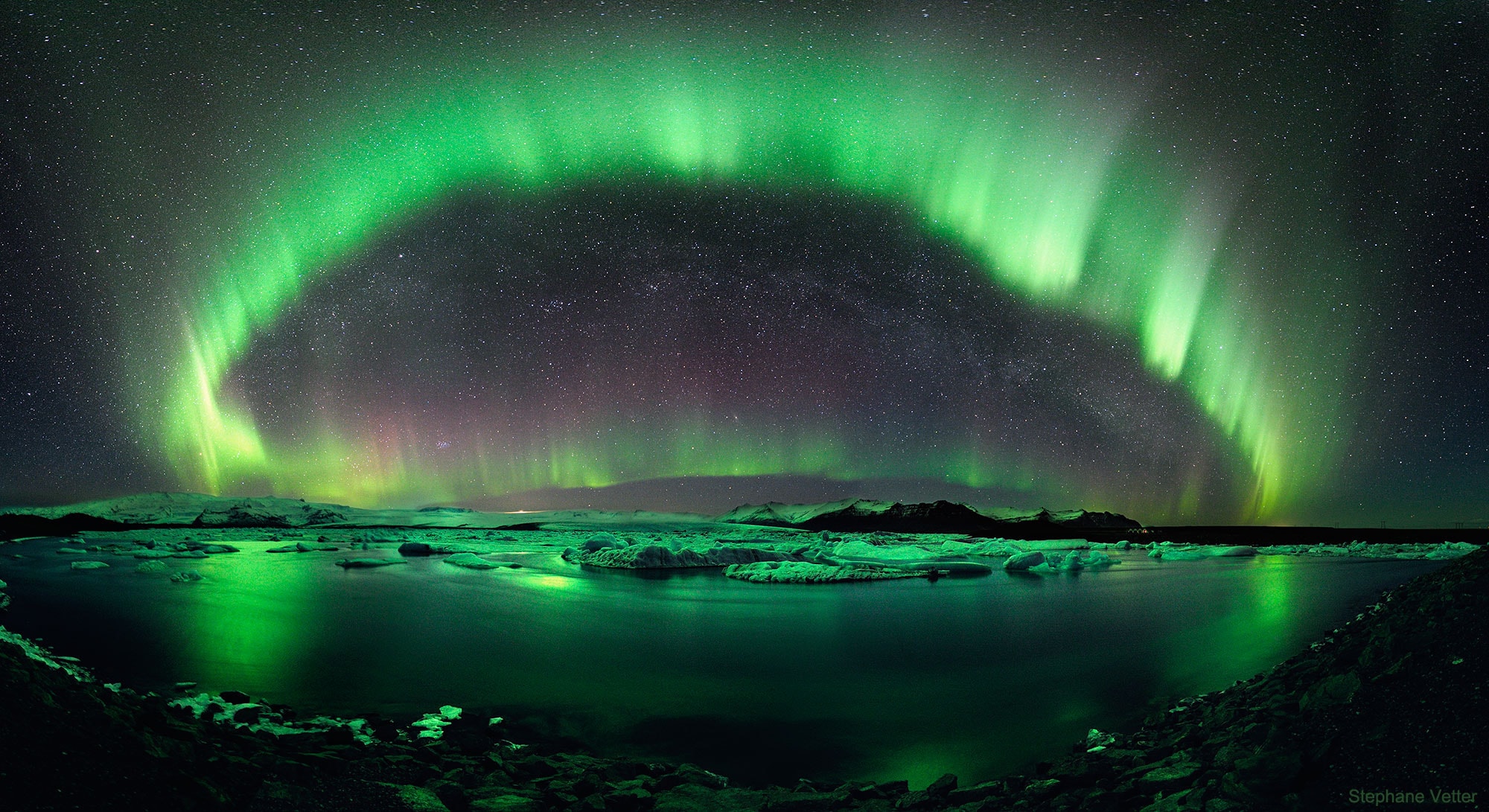 On some nights, the sky is the best show in town. On this night, the sky was not only the best show in town, but a composite image of the sky won an international competition for landscape astrophotography. The featured winning image was taken in 2011 over J�kuls�rl�n, the largest glacial lake in Iceland.  The photographer combined six exposures to capture not only two green auroral rings, but their reflections off the serene lake. Visible in the distant background sky is the band of our Milky Way Galaxy and the Andromeda galaxy. A powerful coronal mass ejection from the Sun caused auroras to be seen as far south as Wisconsin, USA.  As the Sun progresses away from its current low in surface activity toward a solar maximum a few years away, many more spectacular images of aurora are expected.