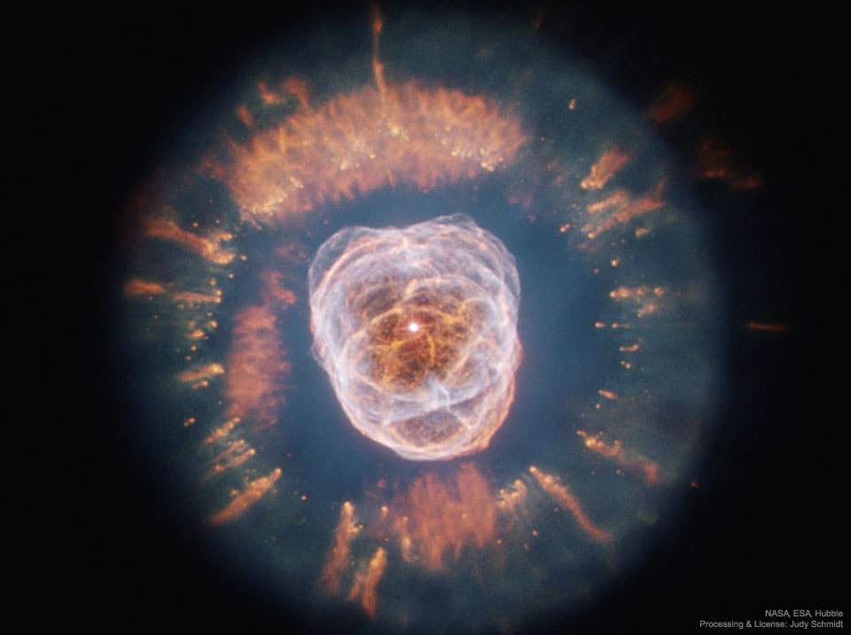 To some, this huge nebula resembles a person's head surrounded by a parka hood.  In 1787, astronomer William Herschel discovered this unusual planetary nebula:  NGC 2392.  More recently, the Hubble Space Telescope imaged the nebula in visible light,  The featured image  of the nebula shows gas clouds so complex they are not fully understood.  NGC 2392 is a double-shelled planetary nebula, with the more distant gas having composed the outer layers of a Sun-like star only 10,000 years ago.  The outer shell contains unusual light-year long orange filaments. The inner filaments visible are being ejected by strong wind of particles from the central star.  The NGC 2392 Nebula spans about 1/3 of a light year and lies in our Milky Way Galaxy, about 3,000 light years distant, toward the constellation of the Twins (Gemini).
